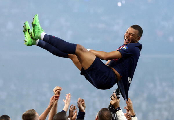 Paris St Germain's Kylian Mbappe celebrates with teammates after winning the Coupe de France