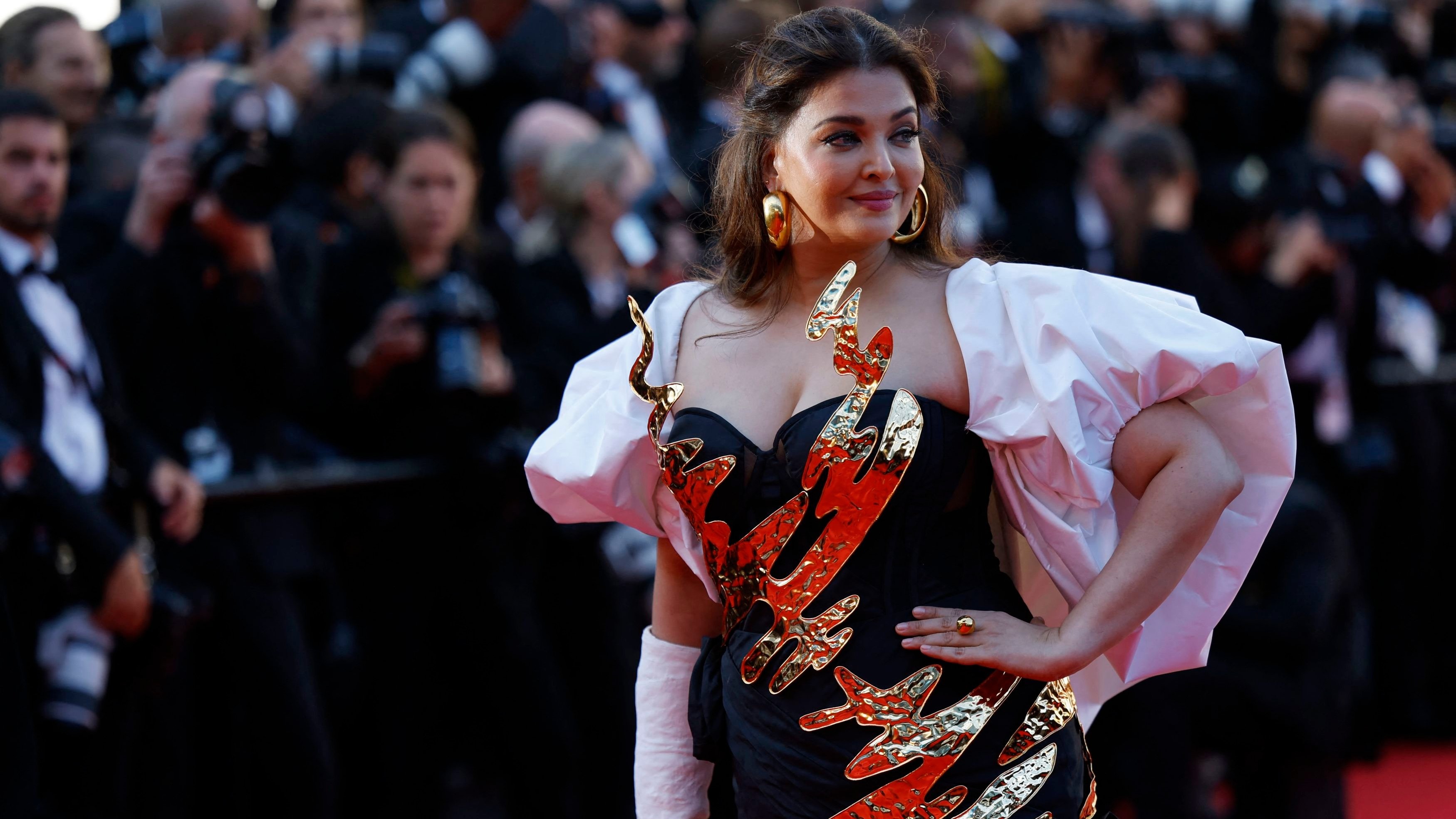 A regular at the Cannes Film Festival for the past two decades, Aishwarya struck a pose in the monochrome gown adorned with 3D metallic elements and golden accents.
