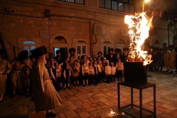 Ultra-Orthodox Jews watch a bonfire built in celebration of the Jewish holiday of Lag B'Omer, in the Mea Shearim neighbourhood of Jerusalem, May 25