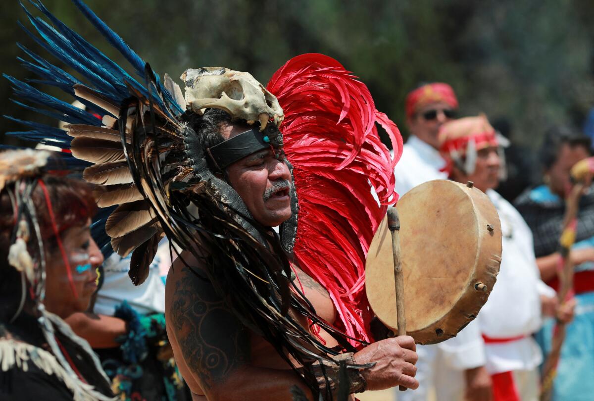 Members of Indigenous communities participate in a rain petition ritual with songs and offerings, in the archaeological site of Cuicuilco, Mexico. 