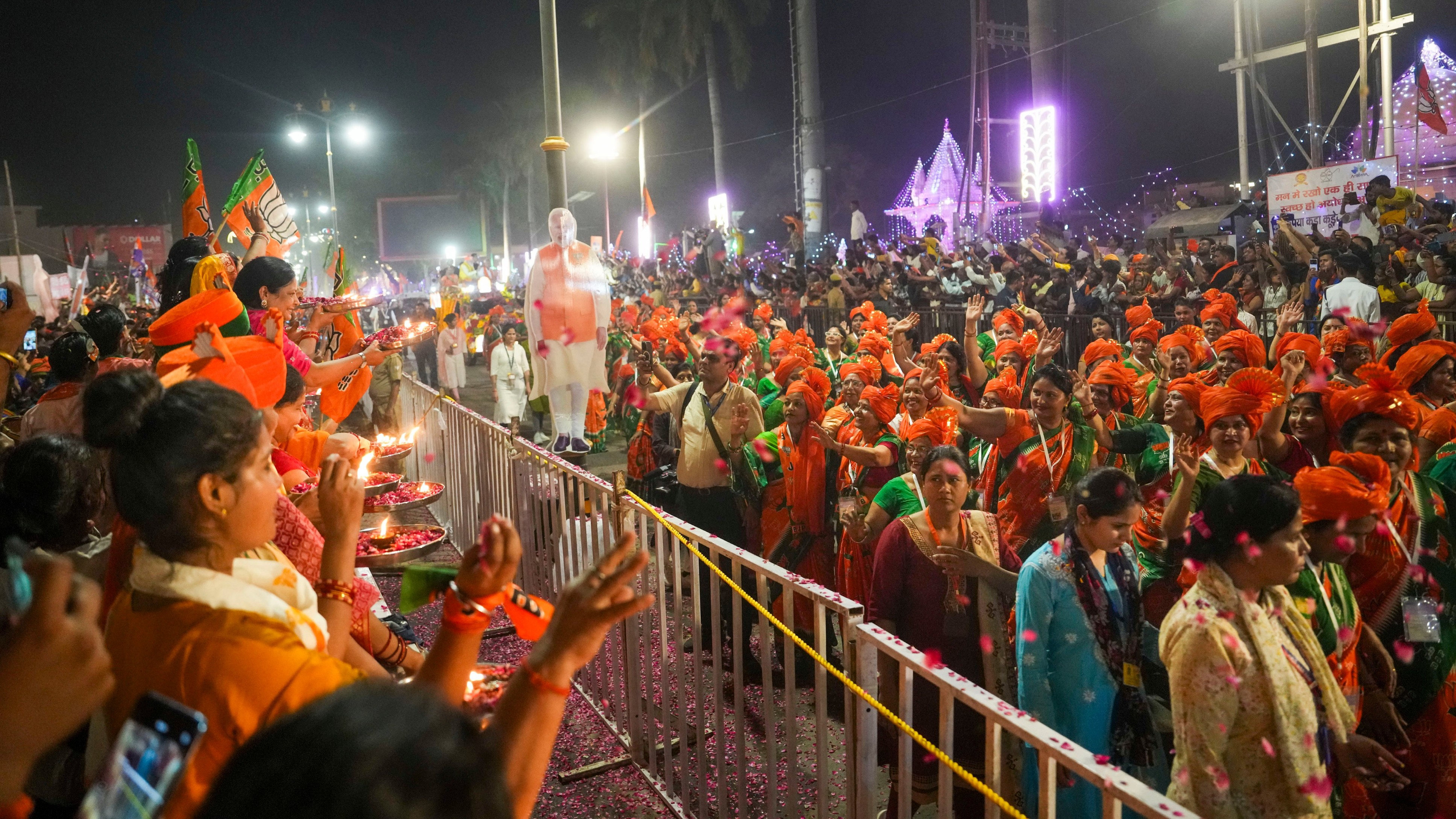 People perform 'aarti' during the roadshow of Prime Minister Narendra Modi for Lok Sabha elections, in Ayodhya.