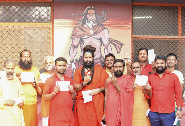 Mahant of Baghambari Math Balveer Giri Maharaj (C) after casting his vote at a polling booth during the sixth phase of Lok Sabha elections, in Prayagraj.