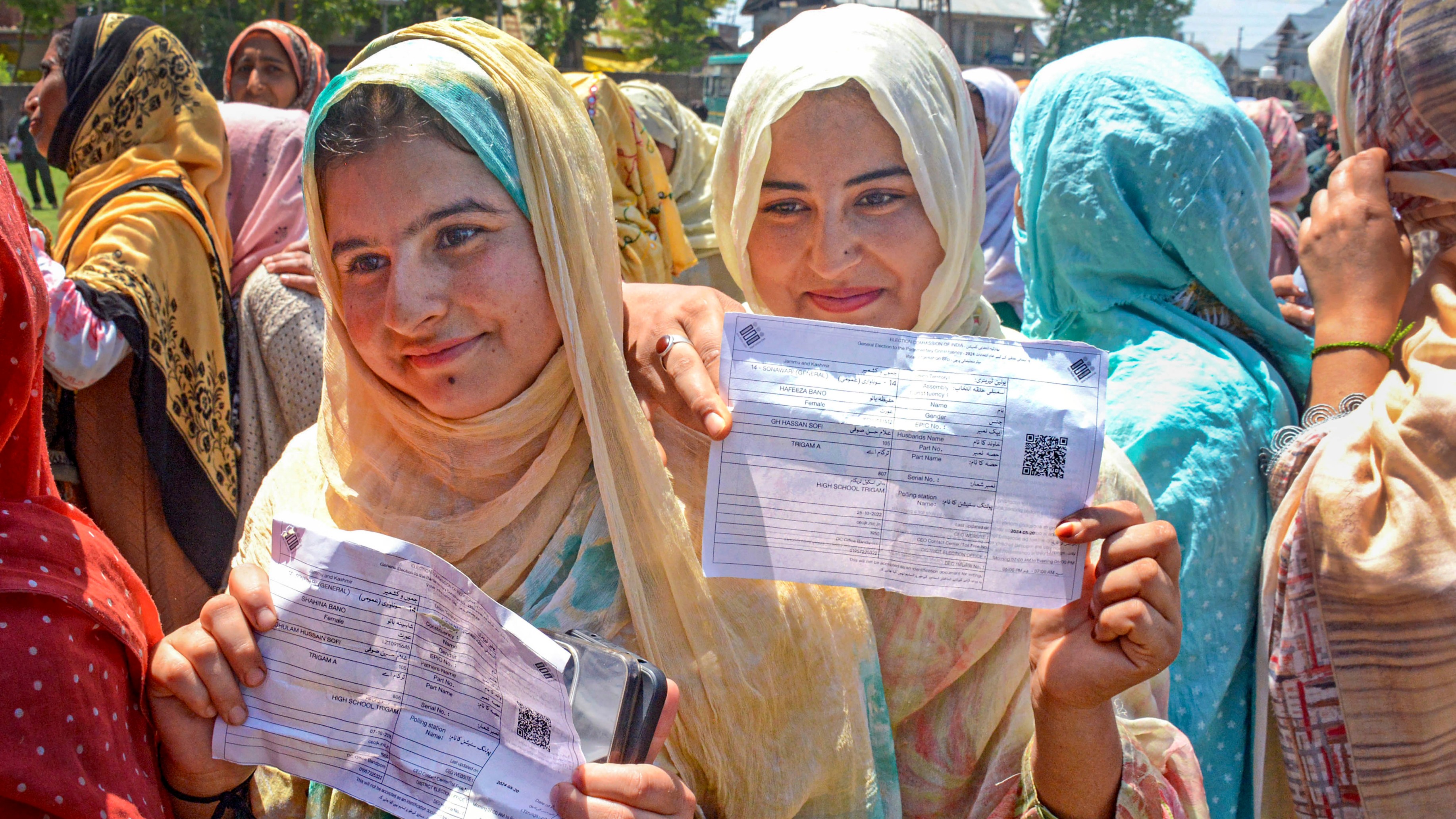 First time voters show their voter slips as they wait at a polling station to cast their votes for the fifth phase of Lok Sabha elections, in Bandipore, J&amp;K.