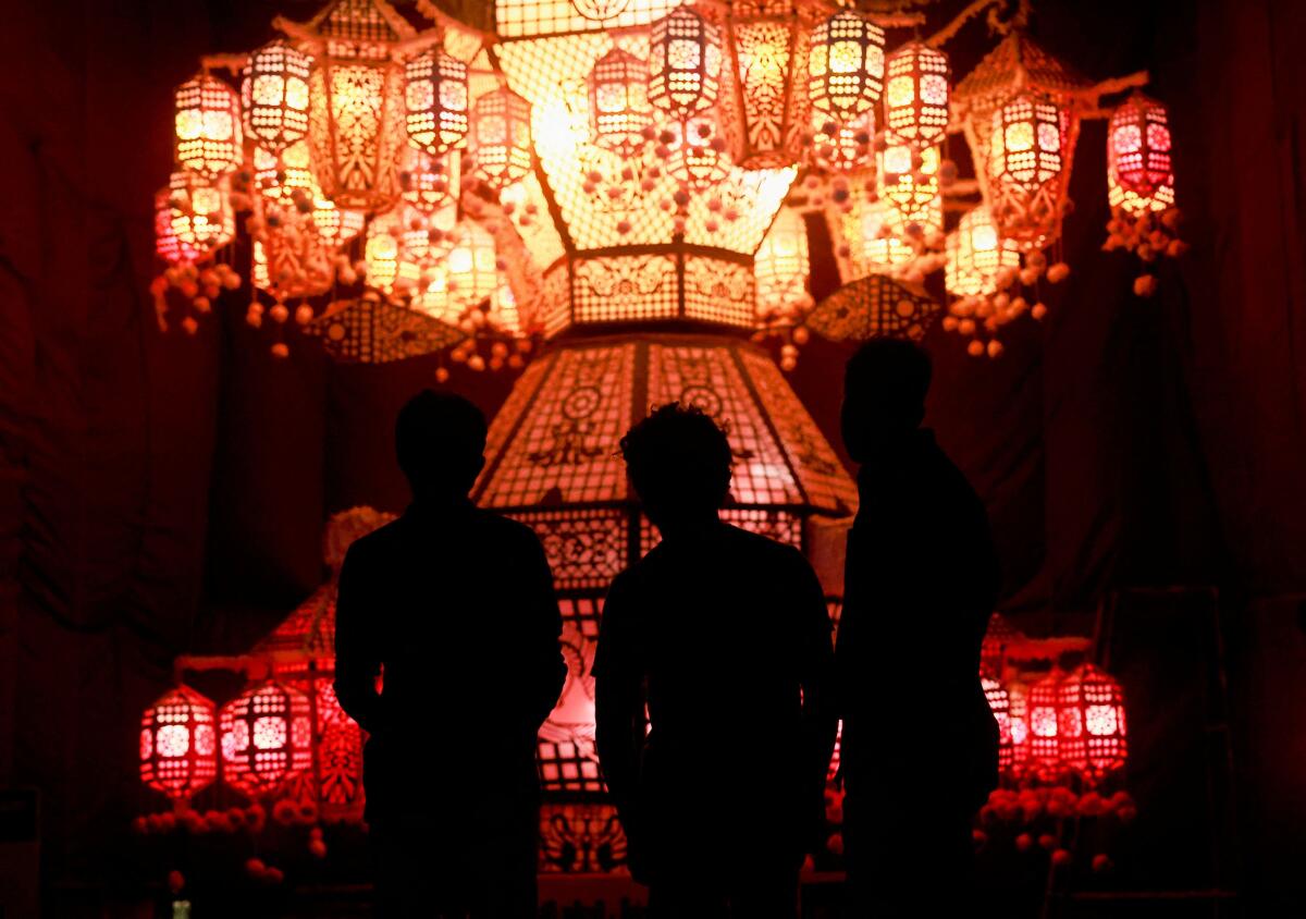 People look at a pandal, a temporary platform to be decorated with illuminated panels illustrating episodes from the life of Buddha, on Vesak Day, an annual celebration of Buddha's birth, enlightenment and death, at the Kelaniya temple in Colombo, Sri Lanka May 23, 2024.