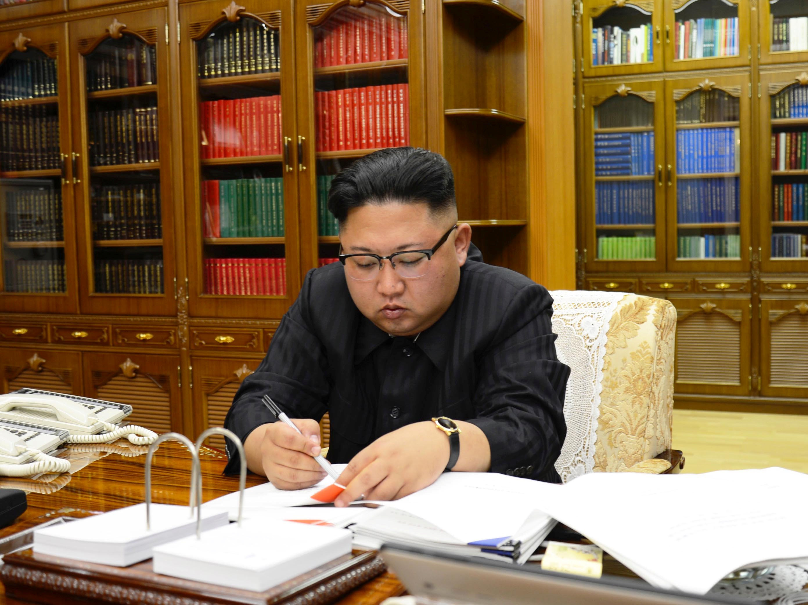 North Korean Leader Kim Jong Un signs the order to carry out the test-fire of inter-continental ballistic rocket Hwasong-14 in this undated photo released by North Korea's Korean Central News Agency (KCNA) in Pyongyang. 