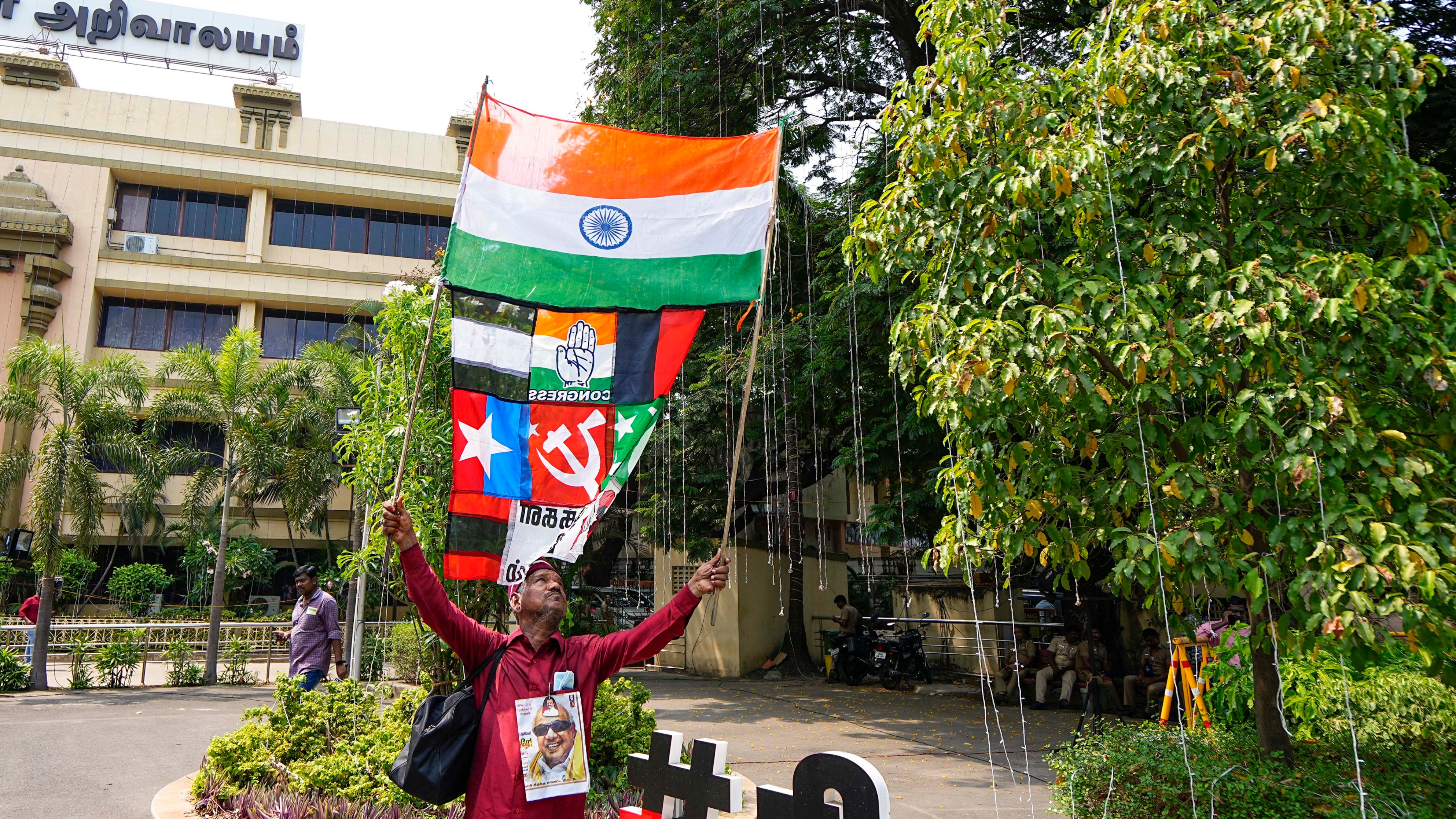 A DMK supporter celebrates the party's lead during counting of votes for Lok Sabha elections, at party headquarters, Anna Arivalayam, in Chennai.