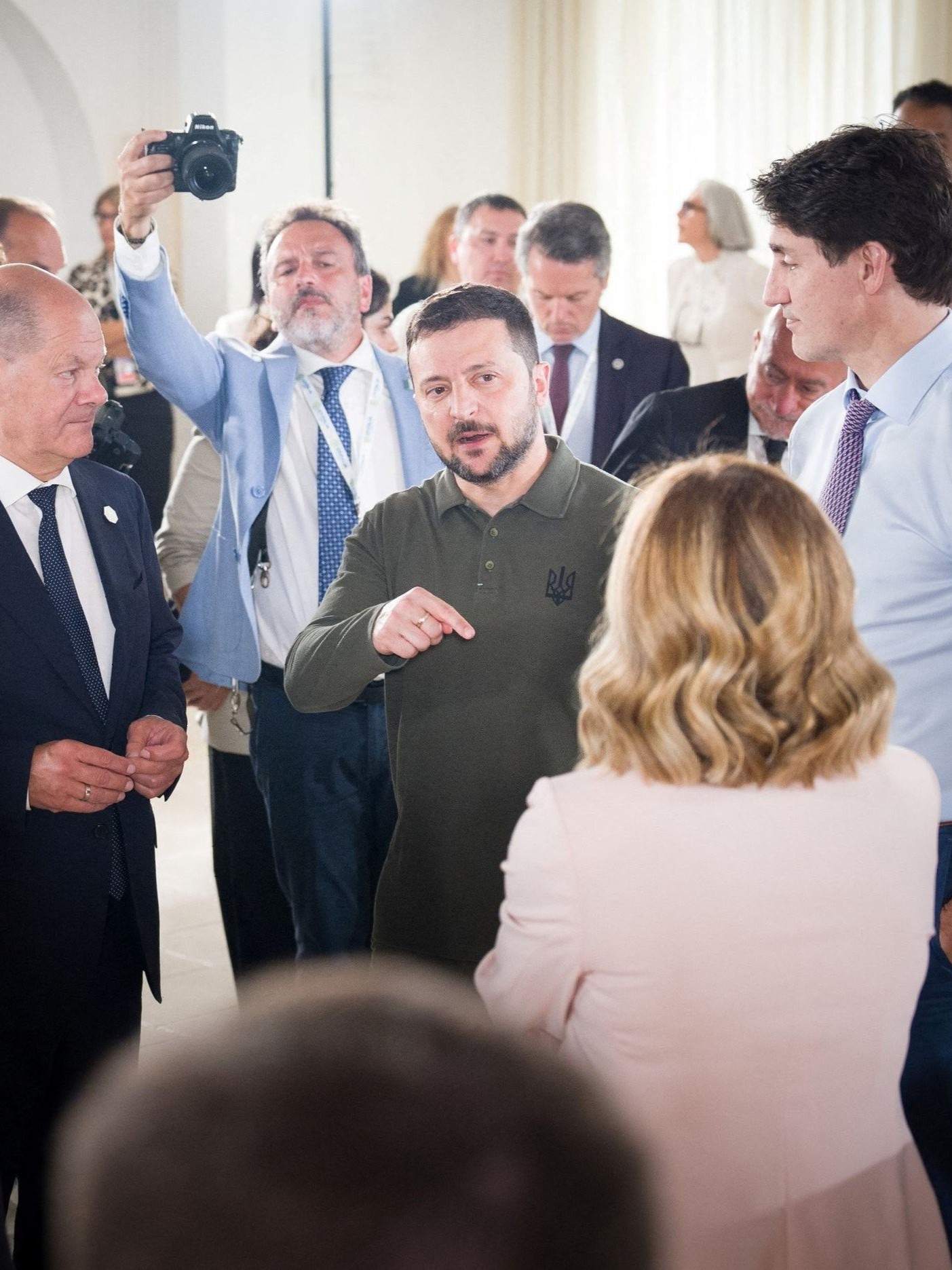 German Chancellor Olaf Scholz listens to Ukrainian President Volodymyr Zelenskiy during a working session at the G7 summit in Fasano, Italy.