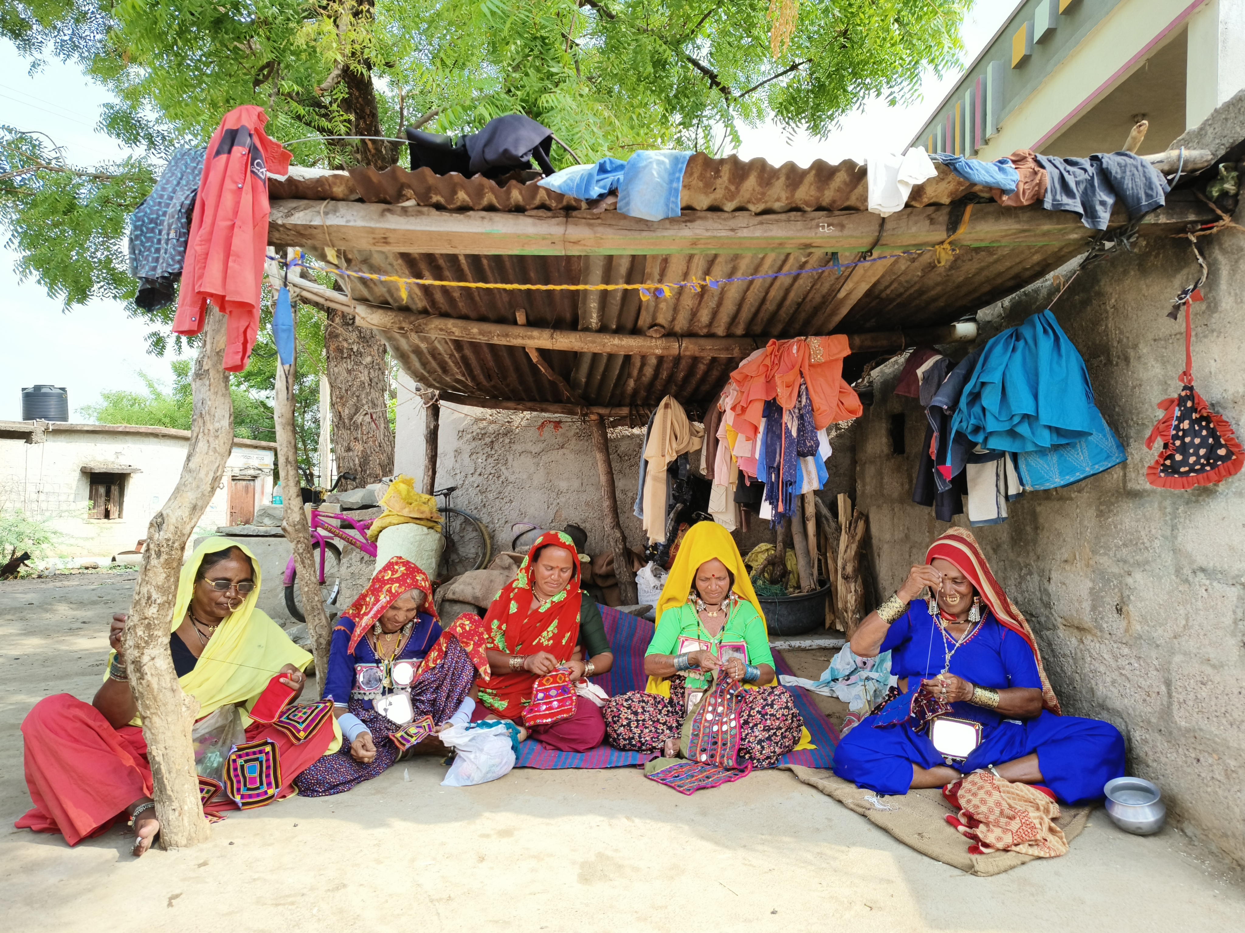 Banjara women engage in traditional embroidery work in Gangunaik thanda in Yadgir district.