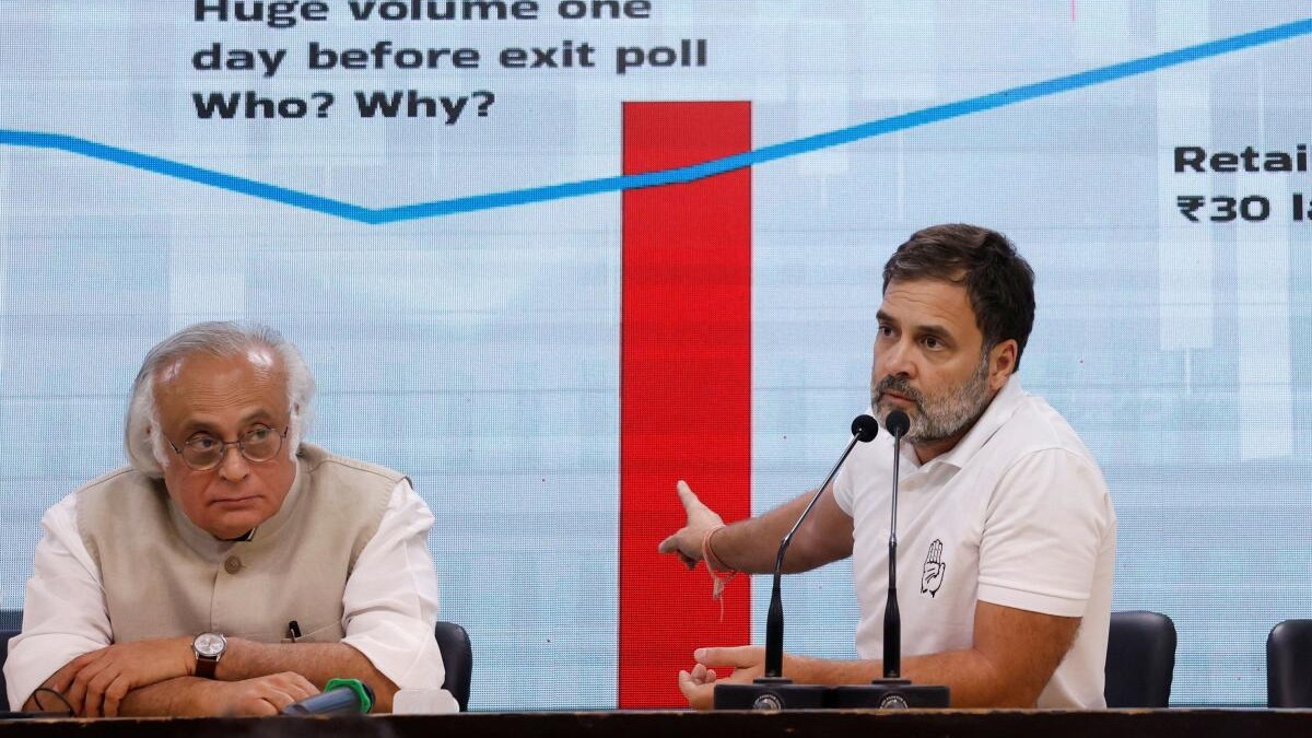 Rahul Gandhi gestures as Jairam Ramesh looks on during a media briefing at the party headquarters in New Delhi. 