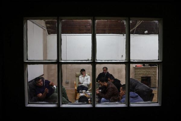 Squatters rest in a room used as a common room of the place they live, which was once a school and is now occupied by squatter activist group Reclaim Croydon, in Croydon, south London, Britain, May 16, 2024. The Reclaim Croydon collective, a squatters' group, has taken over disused commercial premises to provide beds for the homeless, saying it is providing a community-based solution to a broken housing market.   