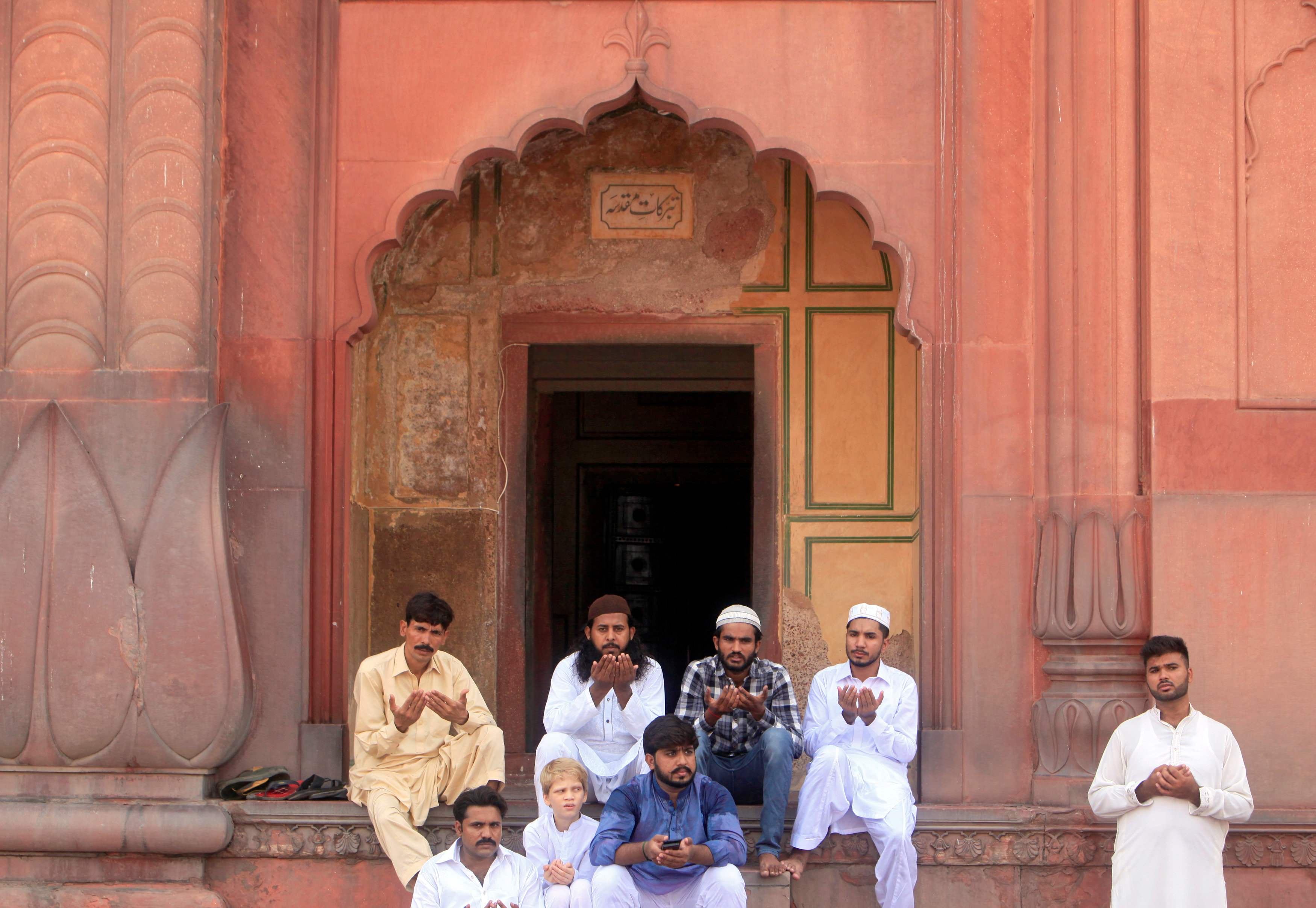 Men say their prayers during Eid al-Fitr to mark the end of the holy fasting month of Ramadan at the Badshahi mosque in Lahore.