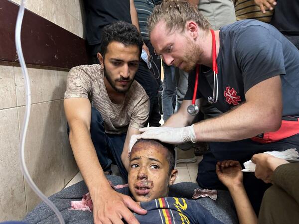 A wounded Palestinian, injured in an Israeli strike on a UNRWA school shelter, receives a treatment at Al-Aqsa Martyrs Hospital, amid the Israel-Hamas conflict, in Deir Al-Balah, in central Gaza Strip,