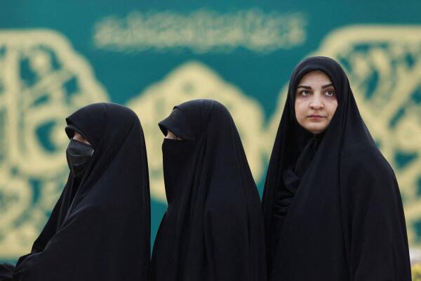 Iranian women queue to vote at a polling station in a snap presidential election to choose a successor to Ebrahim Raisi following his death in a helicopter crash, in Tehran, Iran June 28, 2024. 