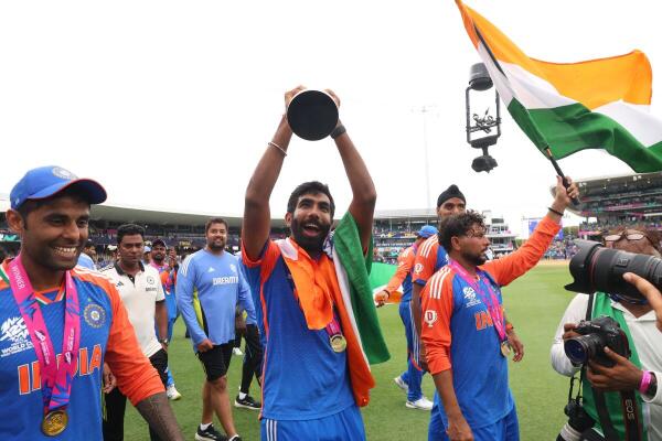 Jasprit Bumrah celebrates with the trophy alongside his team members. Bumrah, who had bowled a beauty to dislodge Reeza Hendricks in the powerplay, made an impact when he was eventually brought back for this remaining two overs, picking up a wicket and conceding only six runs off his final 12 balls.