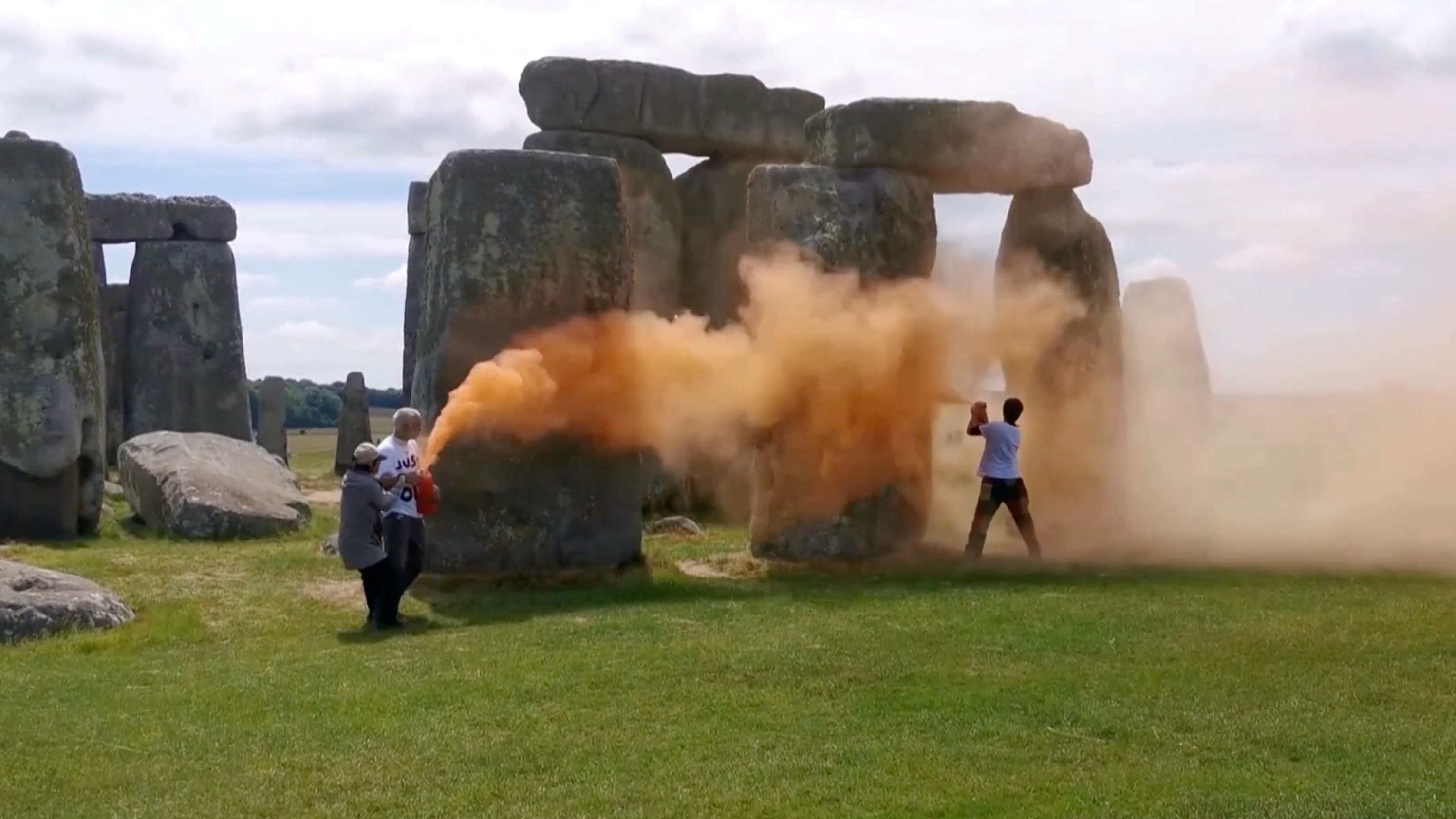 Video released by the group showed activists unleashing fog of orange from a fire extinguisher-style paint sprayer at one of the vertical stones