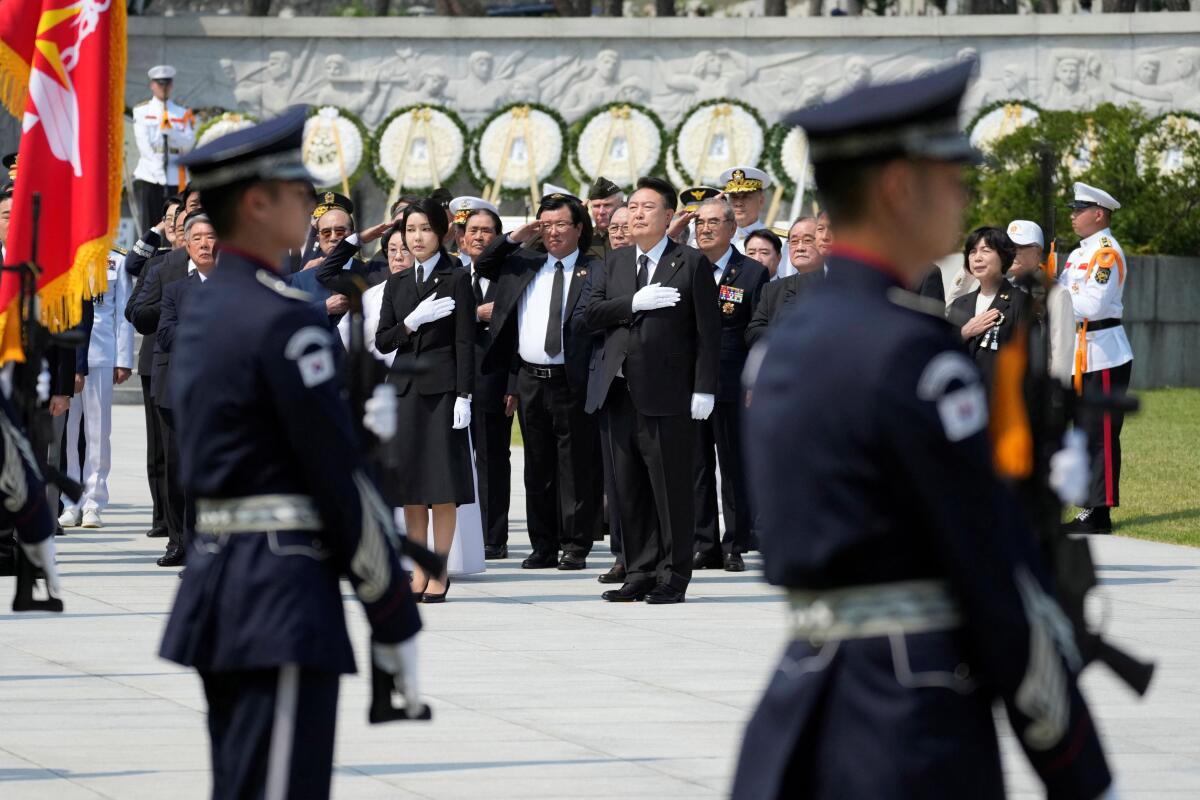 South Korean President Yoon Suk Yeol and his wife Kim Keon Hee salute during a ceremony to mark the 69th Memorial Day at the Seoul National Cemetery in Seoul, South Korea, Thursday, June 6, 2024.