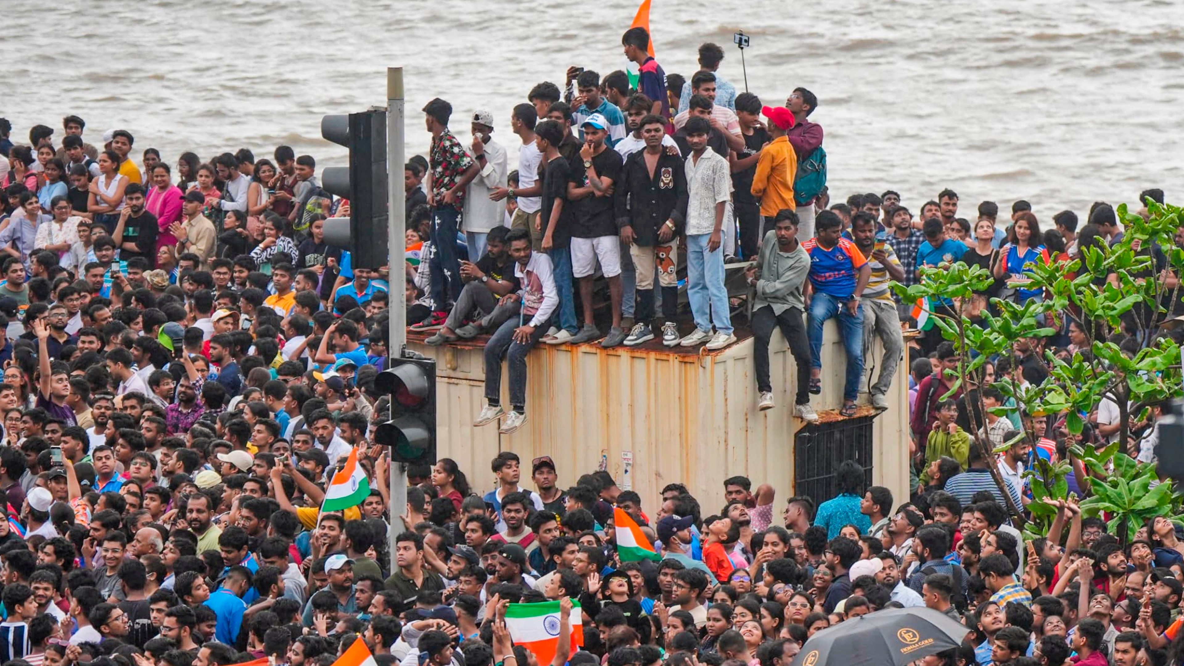 Fans gather ahead of the T20 World Cup-winning Indian cricket team's open bus victory parade, in Mumbai.