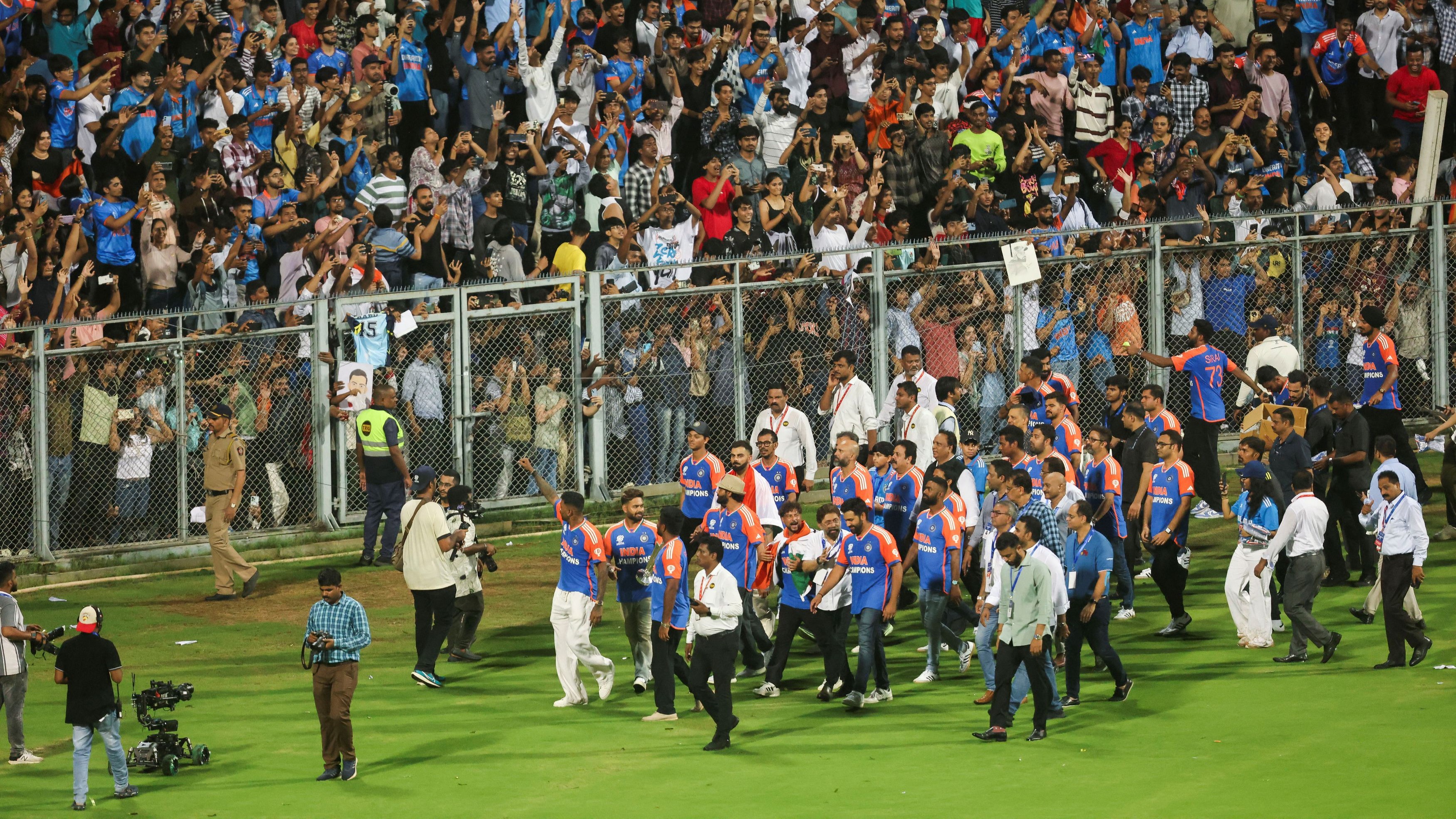 Indian cricket team players celebrate as they take a victory lap around the Wankhede stadium after winning the ICC men's T20 World Cup, in Mumbai.
