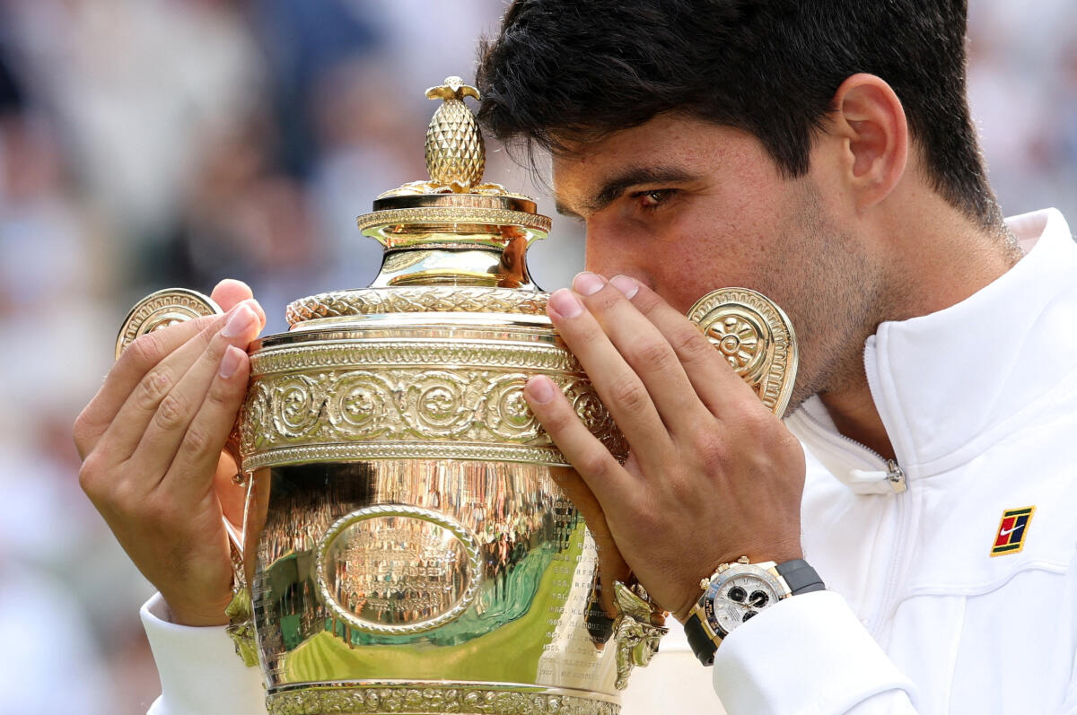 Spain's Carlos Alcaraz celebrates with the trophy after winning the Wimbledon men's singles final against Serbia's Novak Djokovic.