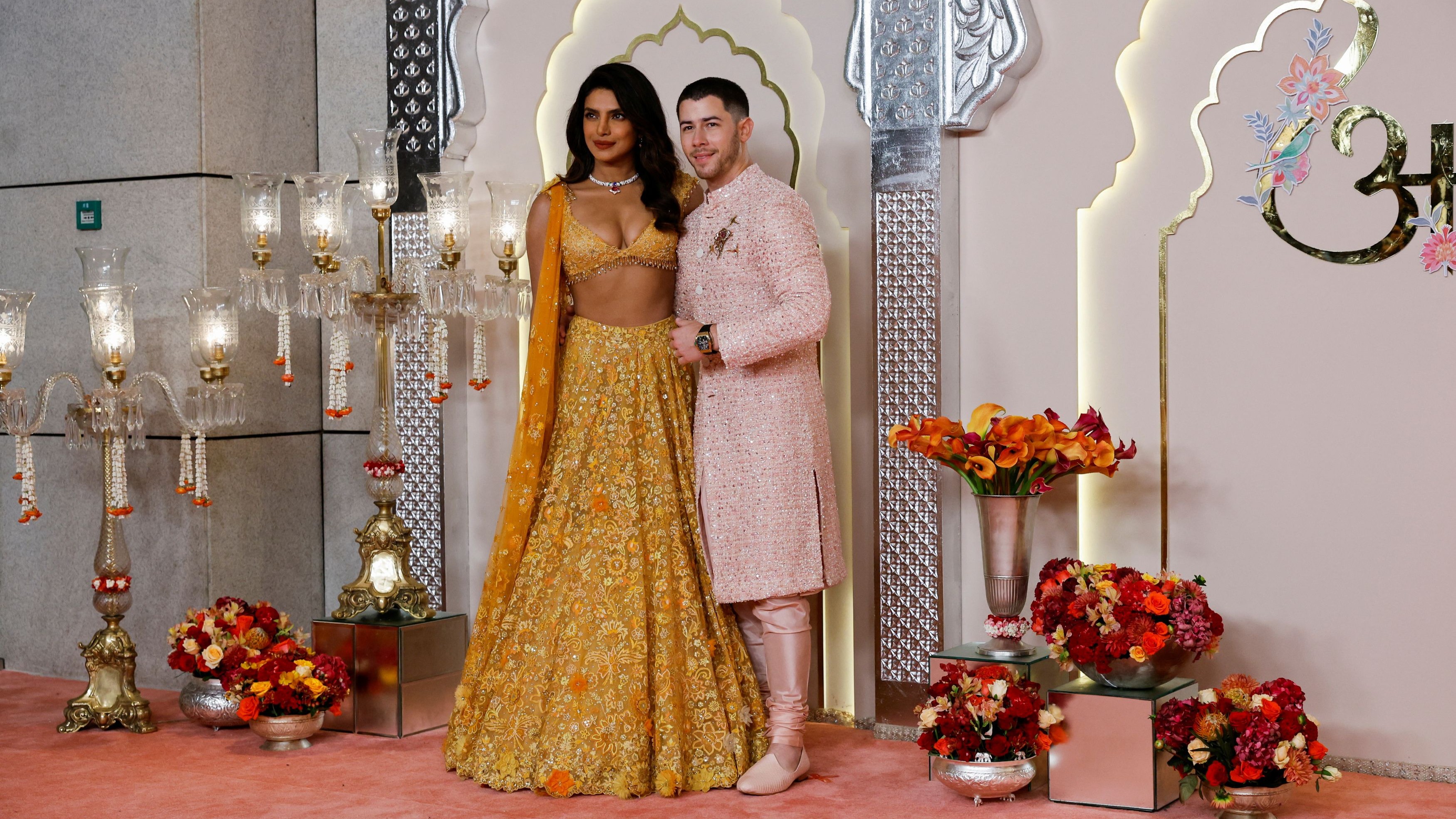 Priyanka and Nick pose for the cameras as they arrive for Anant Ambani and Radhika Merchant's wedding.