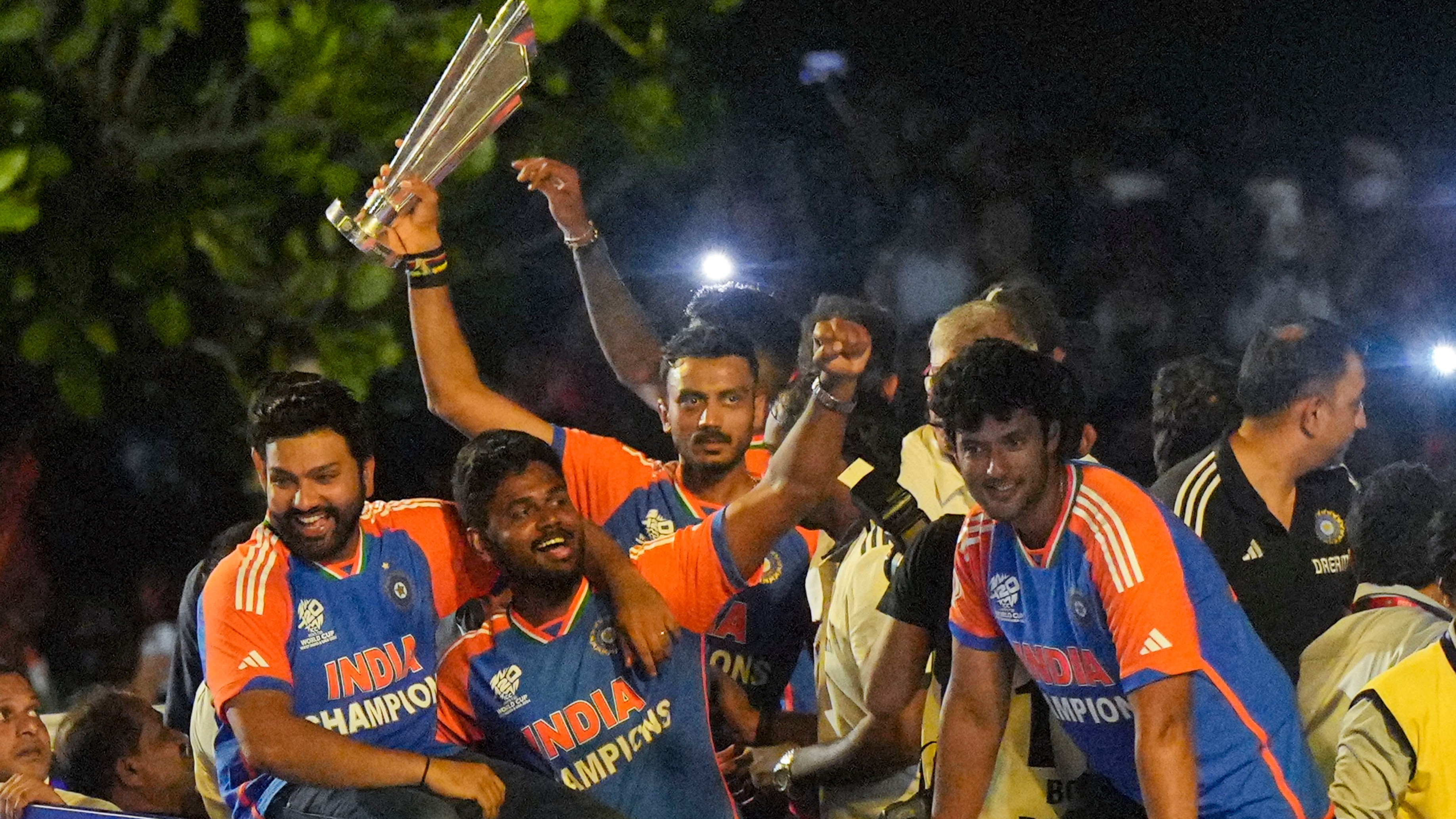 The T20 World Cup-winning Indian cricket team captain Rohit Sharma with players Sanju Samson, Axar Patel, Shivam Dube and others during their open bus victory parade, in Mumbai.