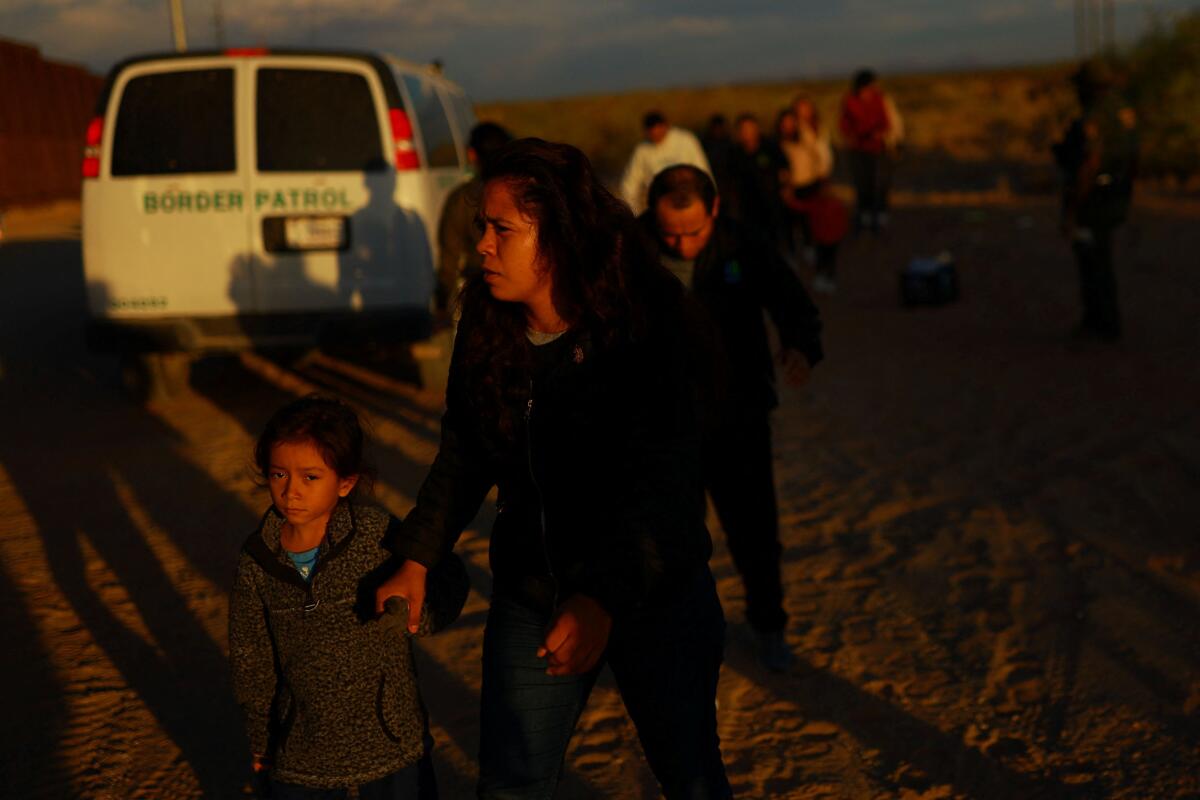 Migrants are detained by U.S. Border Patrol agents after crossing into the United States from Mexico, in Sunland Park, New Mexico.