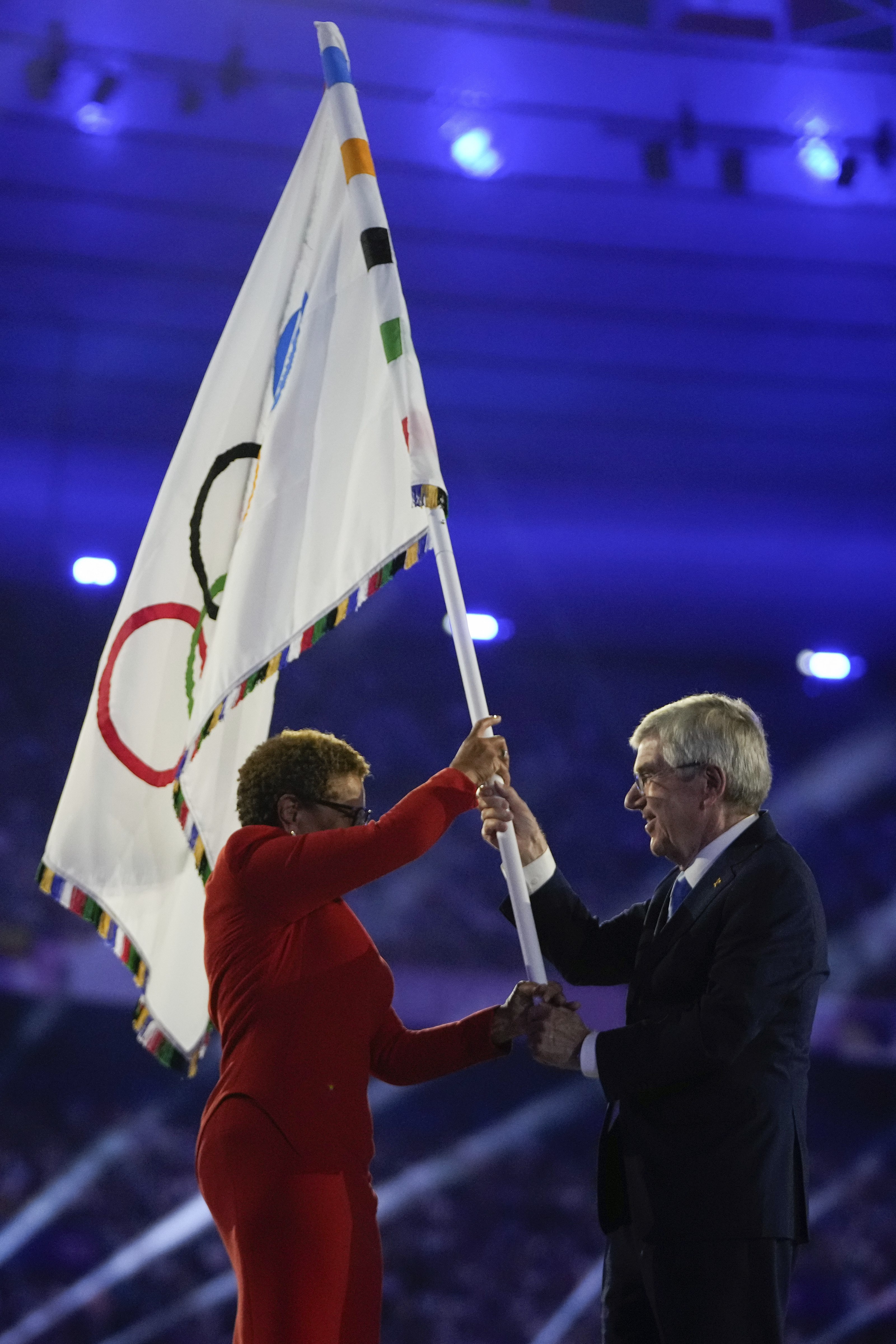 IOC President Thomas Bach (right) hands the Olympic flag to Los Angeles Mayor Karen Bass. LA will host the 2028 edition of the Olympics. 