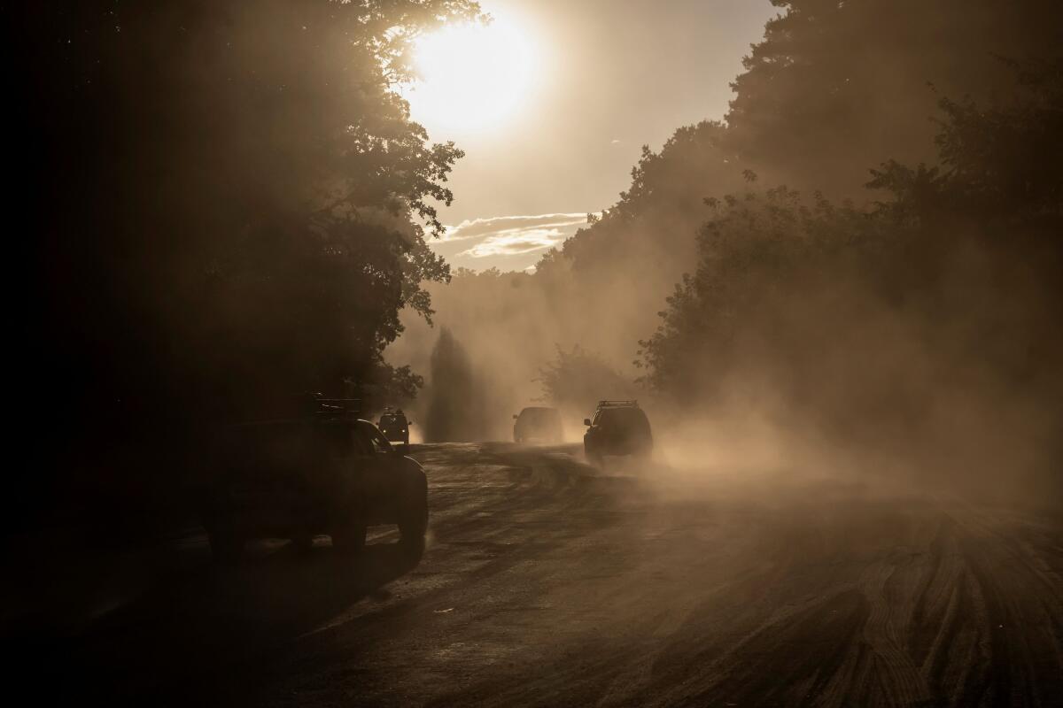 Ukrainian servicemen ride military vehicles near the Russian border in Sumy region. 