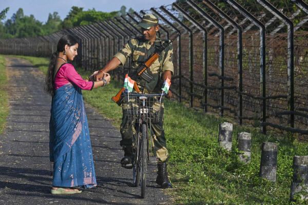 A woman ties 'rakhi' on the wrist of a Border Security Force (BSF) jawan ahead of Raksha Bandhan festival, along the India-Bangladesh border, near Balurghat in Dakshin Dinajpur district, West Bengal.
