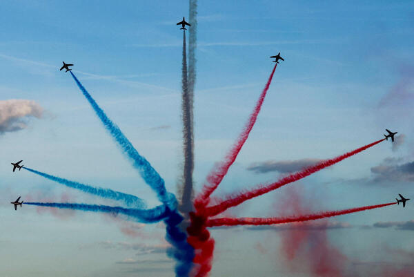 Aircrafts of the Patrouille de France fly over Paris during a parade at the Champs-Elysees avenue for all the French athletes who participated in the 2024 Olympics and Paralympics, in Paris, France 