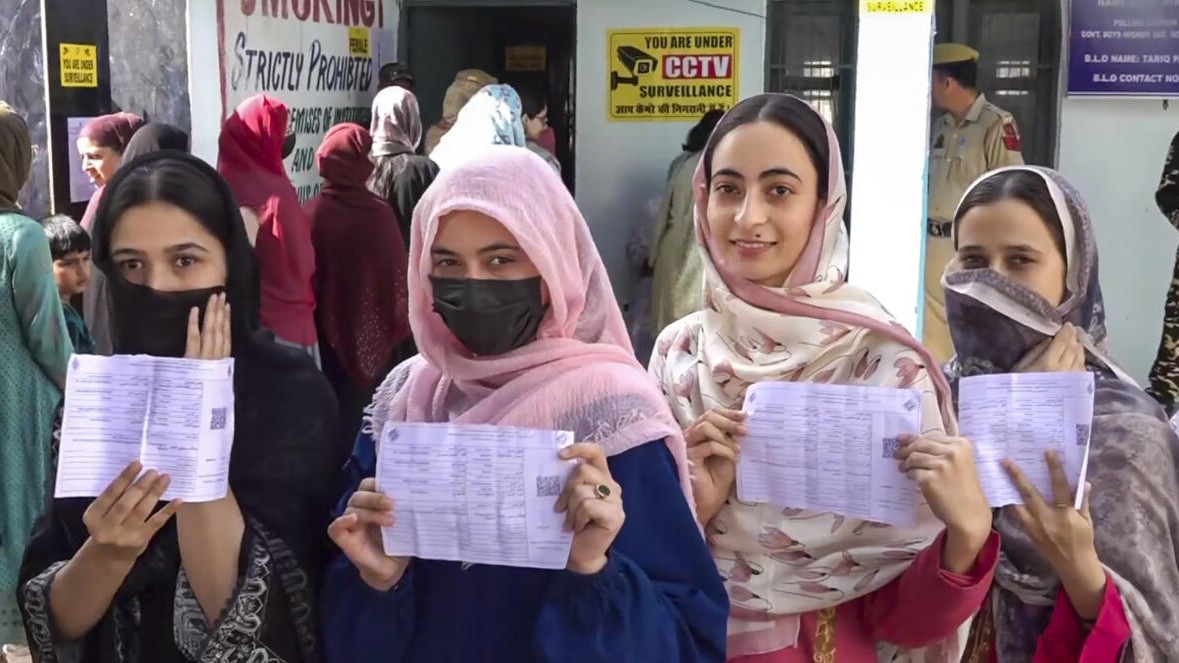 Women voters show their voting slips at a women-only polling station.