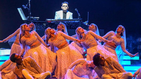 A R Rahman sitting with his paino at the Centre stage.