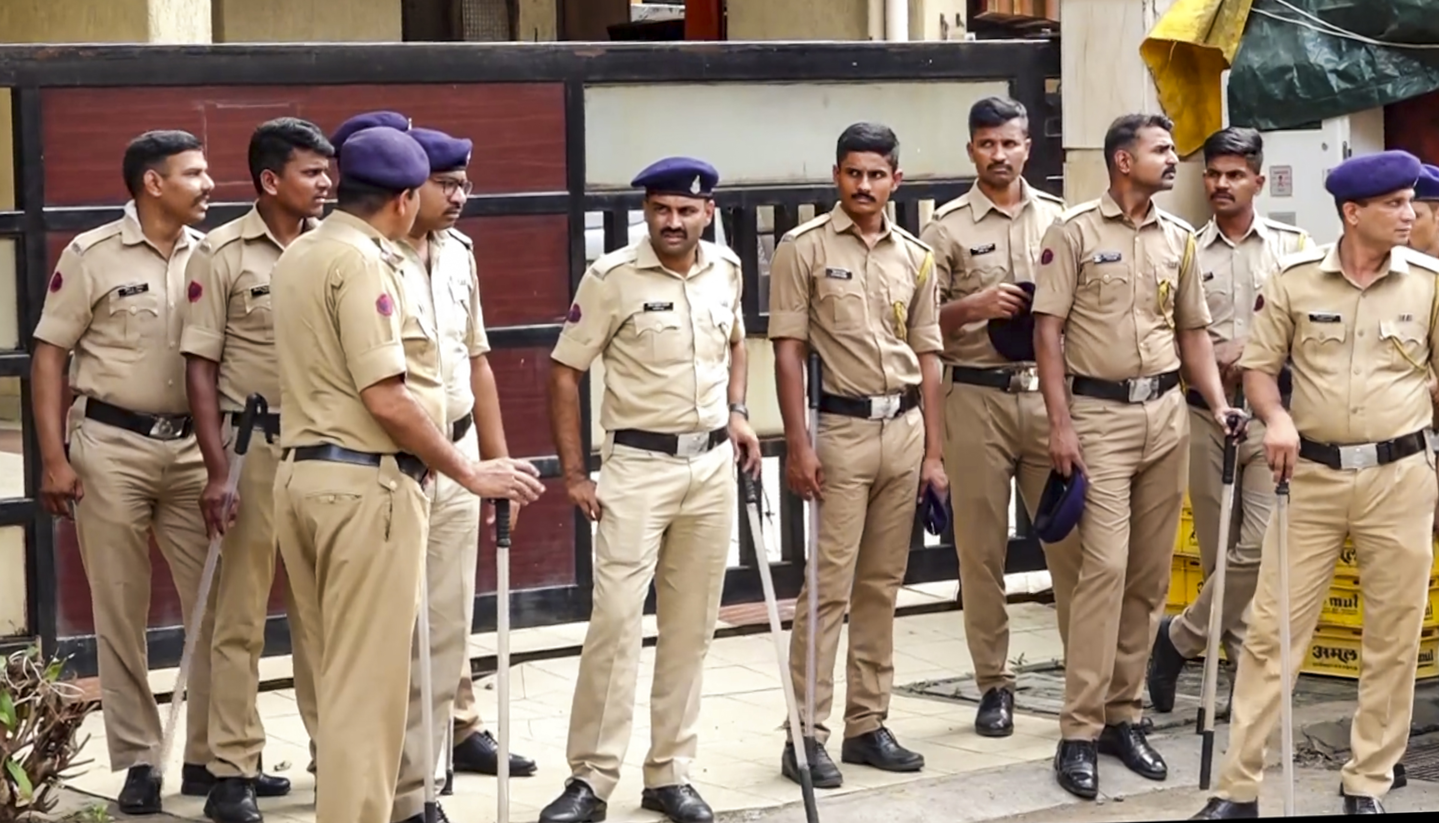 Security personnel stand guard outside deceased NCP leader Baba Siddique's residence, in Mumbai, Sunday, Oct. 13, 2024.