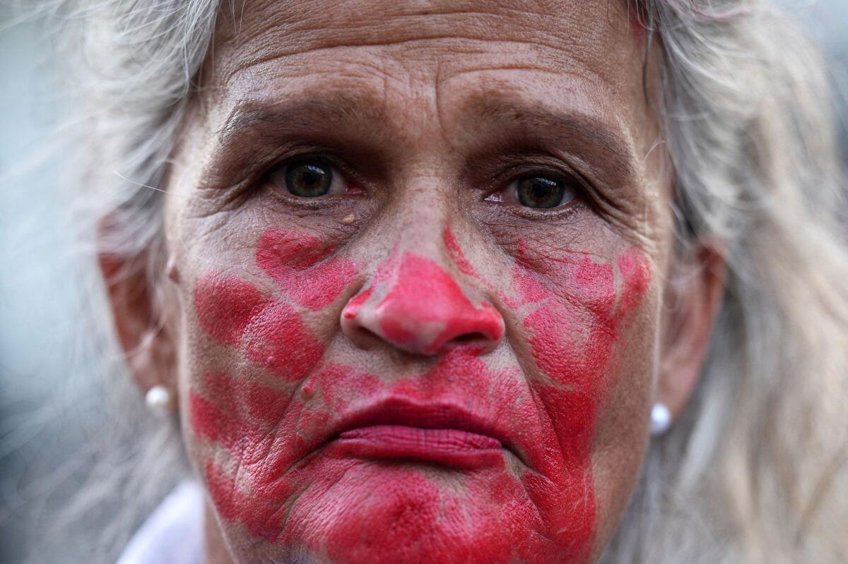 A woman participates in a vigil held by relatives of detained Venezuelans outside the headquarters of the Bolivarian National Intelligence Service (SEBIN) known as "Helicoide", in Caracas, Venezuela.
