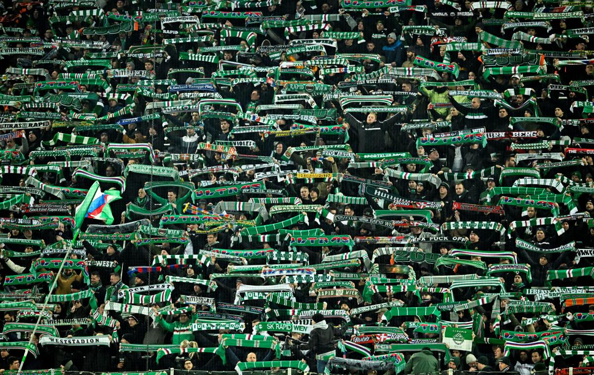 Rapid Vienna fans display scarfs inside the stadium before the match.