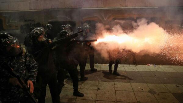 A police officer fires a weapon during a rally of opposition parties' supporters, who protest against the new government's decision to suspend the European Union accession talks and refuse budgetary grants until 2028, in Tbilisi, Georgia