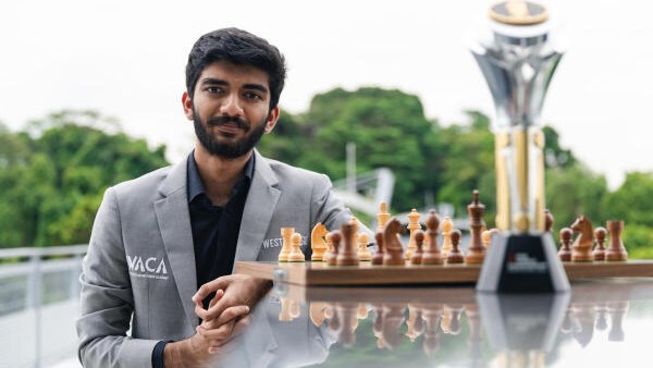 India's D Gukesh poses for photographs with the FIDE World Chess Championship 2024 trophy, in Singapore. 