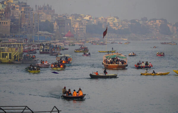 Tourists take a boat ride on Ganga river, in Varanasi.