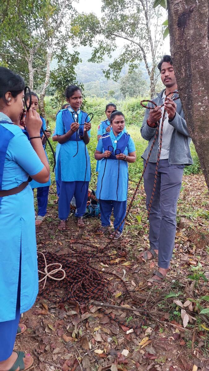Suhan Sudhakar from Bowline Adventure camp shares techniques of tying life-saving knots to Rangers from Kavoor Government First Grade college (GFGC) at a two-day camp organised in  Moolarahalli near Mudigere