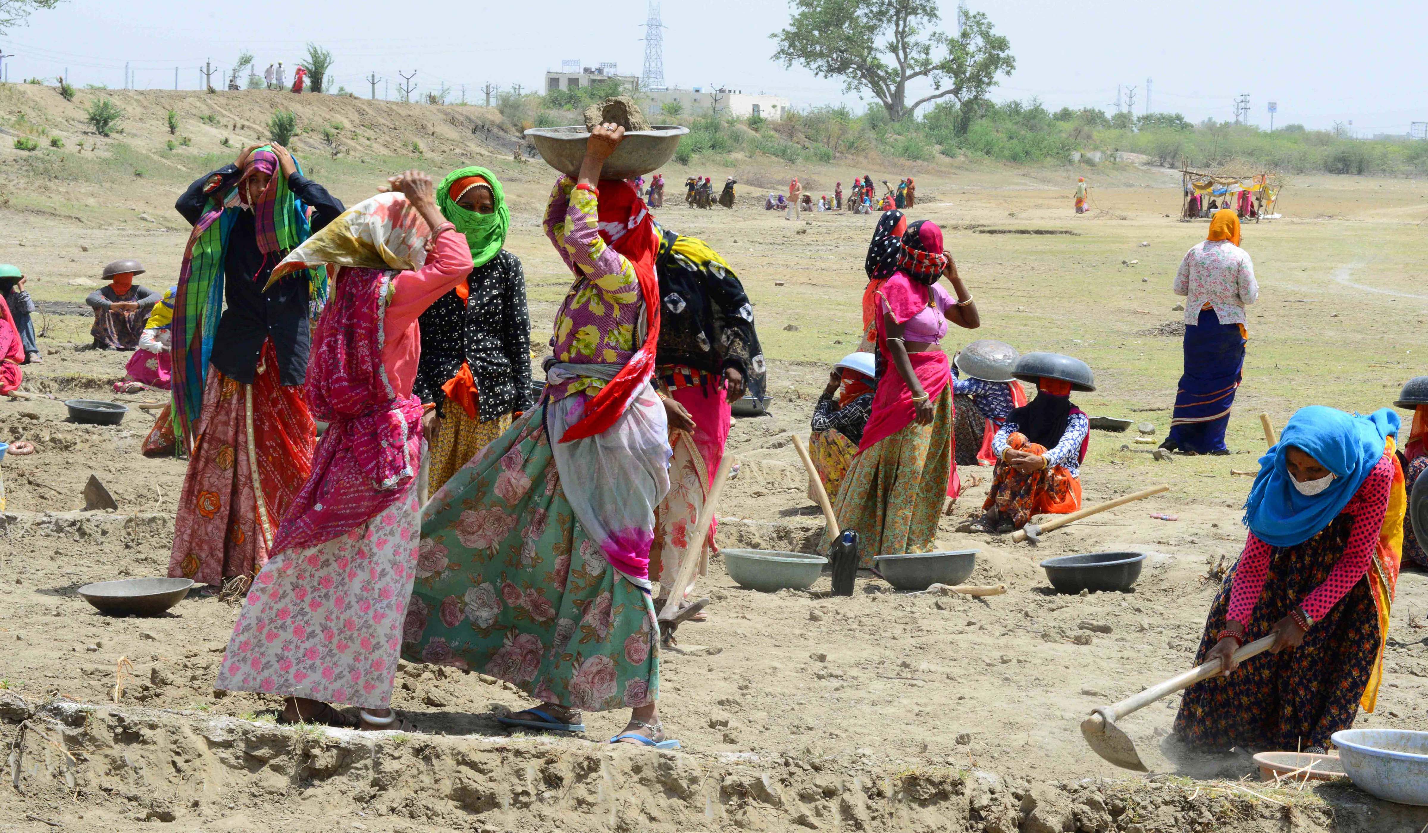  Labourers under Mahatma Gandhi National Rural Employment Guarantee Act (MNREGA) work at a site in Rajasthan.