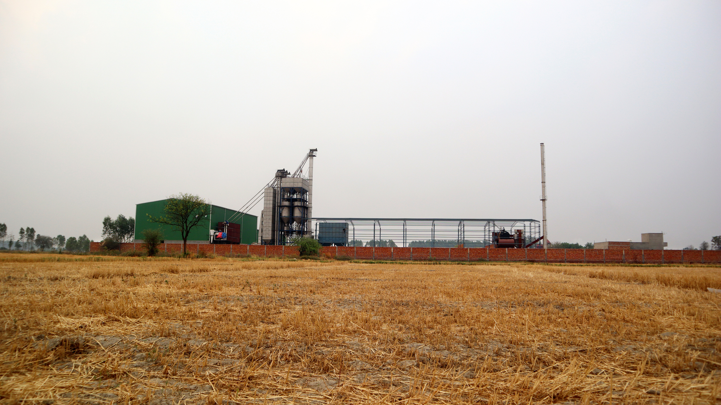 Image showing a rice mill and farm lands. For representational purpose.