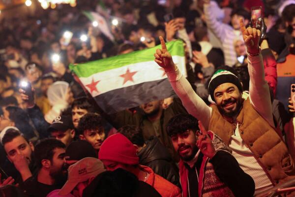 A person reacts as people gather during New Year's celebrations, after the ousting of Syria's Bashar al-Assad, in Damascus, Syria, January 1, 2024.