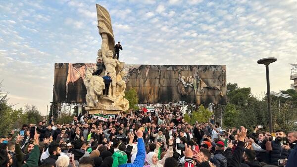 People gather at Saadallah al-Jabiri Square as they celebrate, after Syria's army command notified officers on Sunday that President Bashar al-Assad's 24-year authoritarian rule has ended.