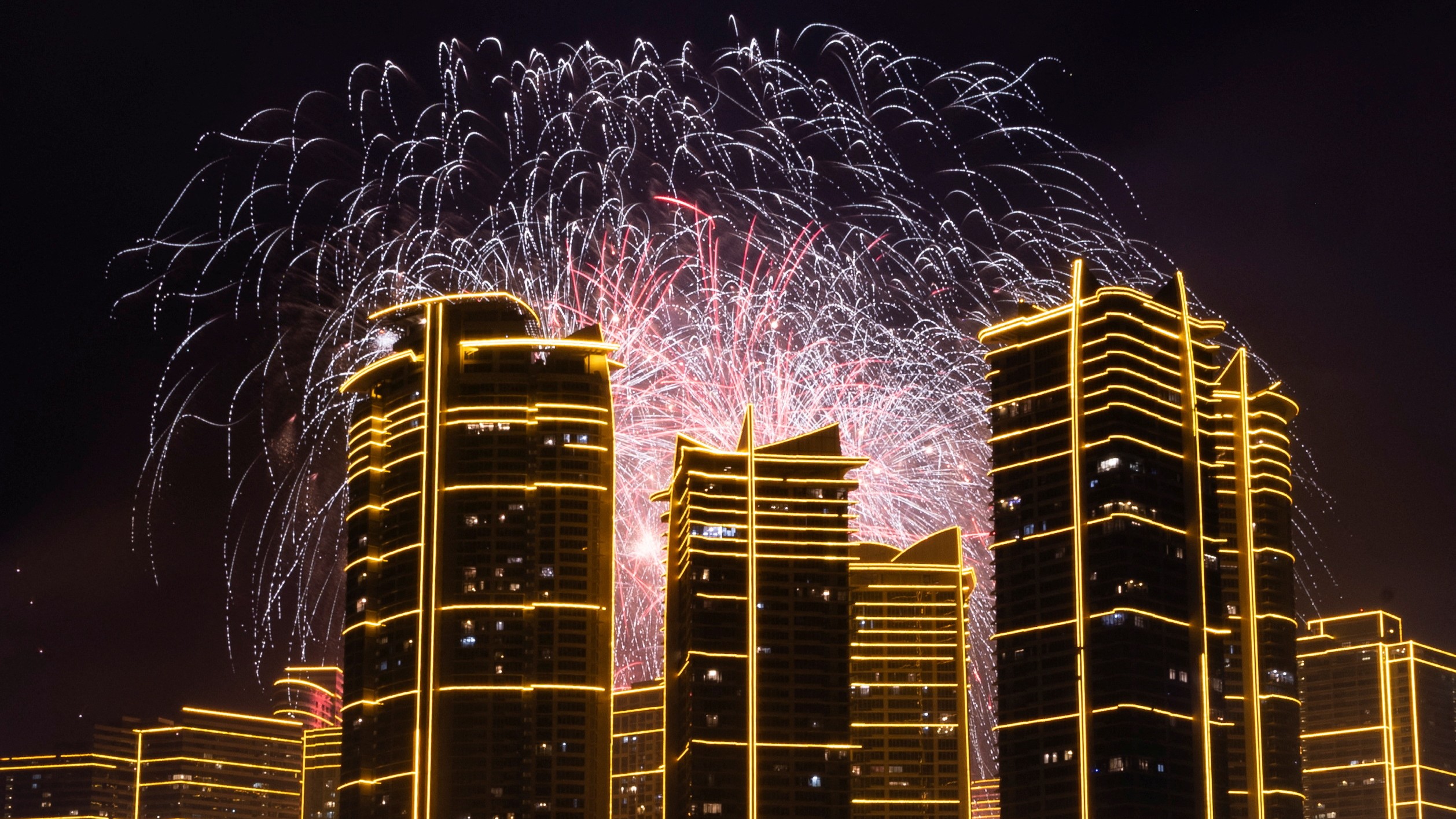 Fireworks explode over Rockwell Center in celebration of the New Year in Mandaluyong City, Metro Manila, Philippines.