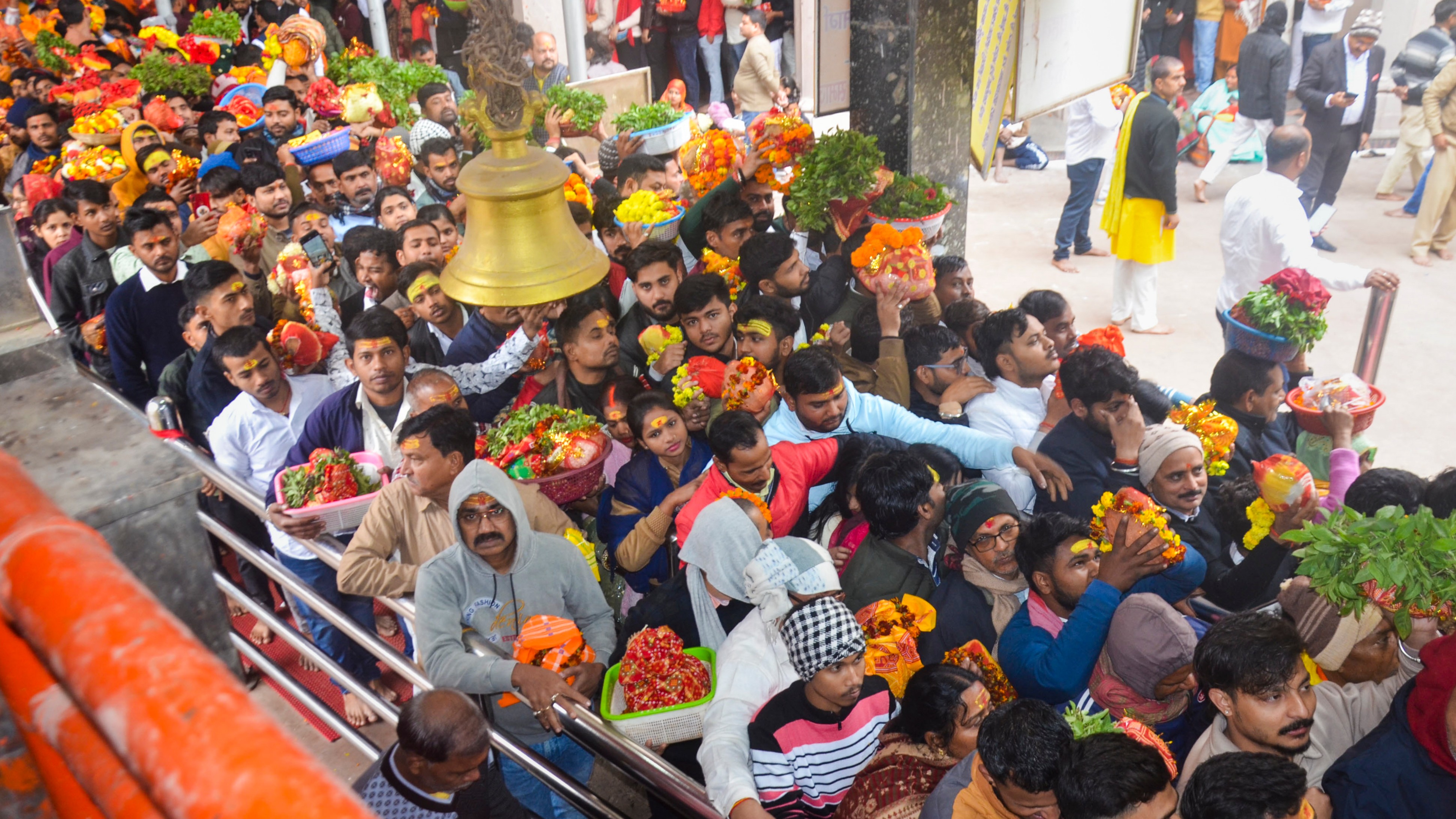 Devotees wait to offer prayers at the Vindhyachal Temple on the first day of New Year 2025, in Mirzapur, Uttar Pradesh.