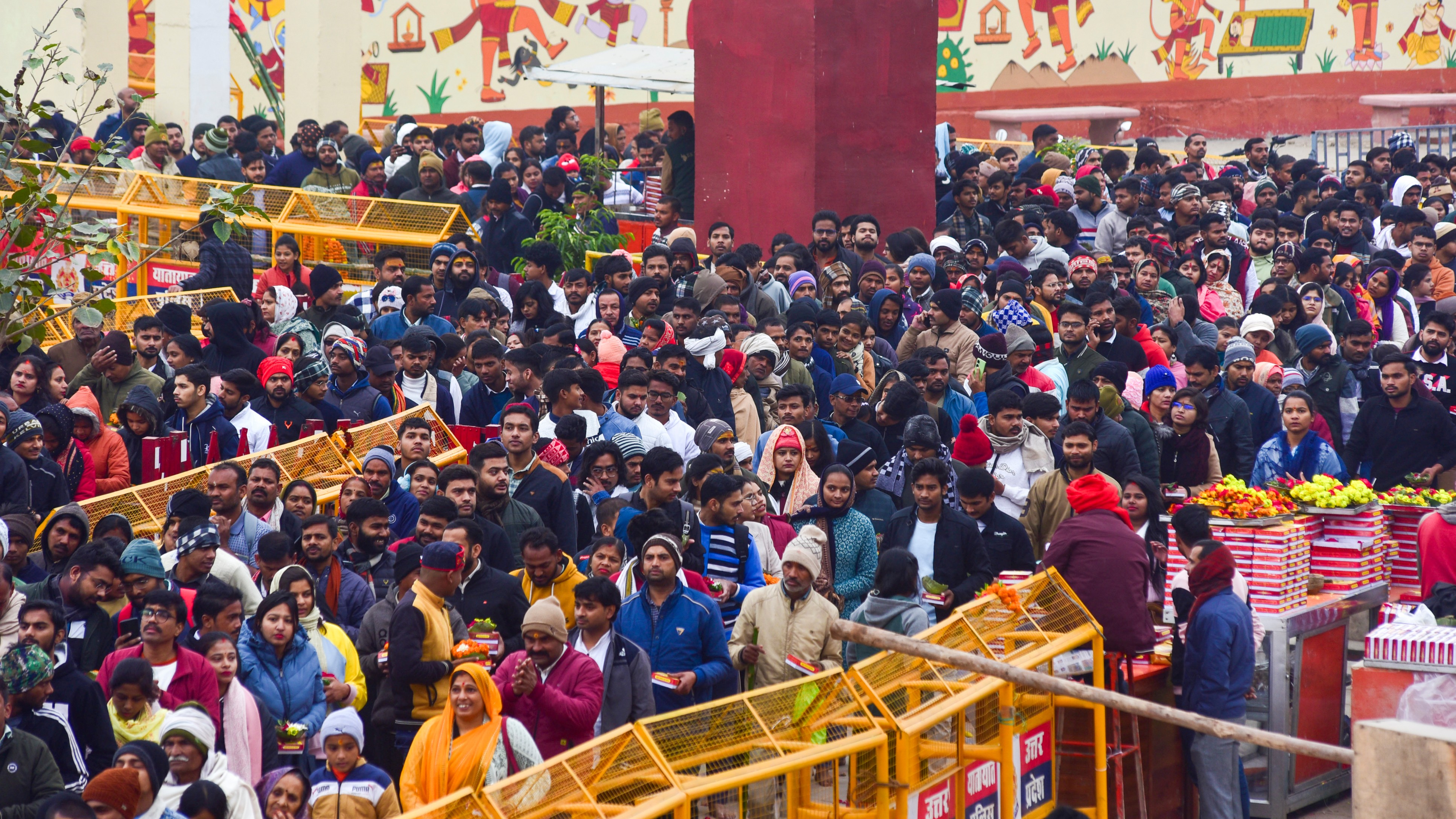 Devotees wait to offer prayers at Shri Bade Hanuman Ji temple on the first day of New Year 2025, in Prayagraj, Uttar Pradesh.