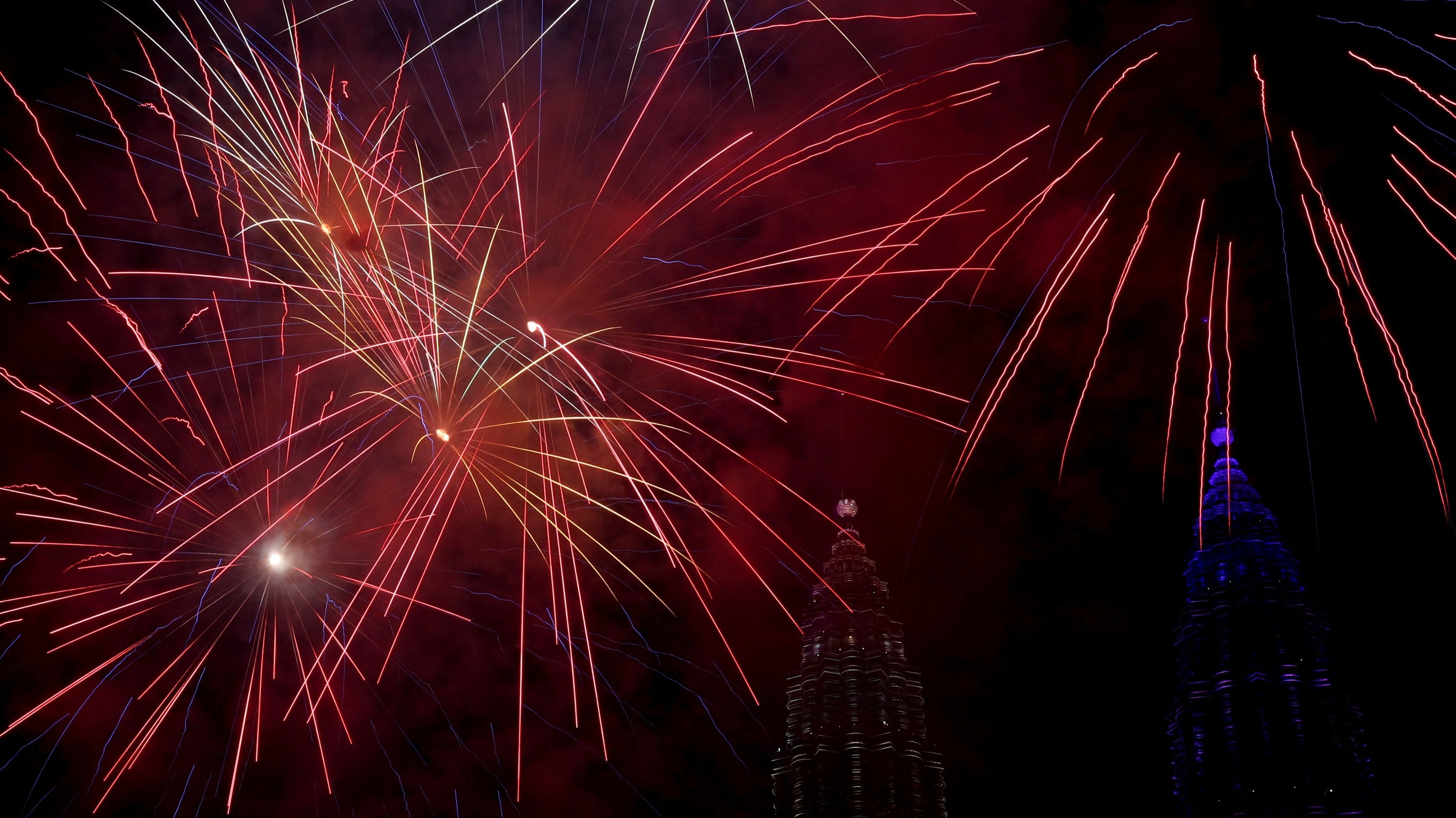 Fireworks explode over Petronas Twin Tower during the New Year's celebrations in Kuala Lumpur, Malaysia.