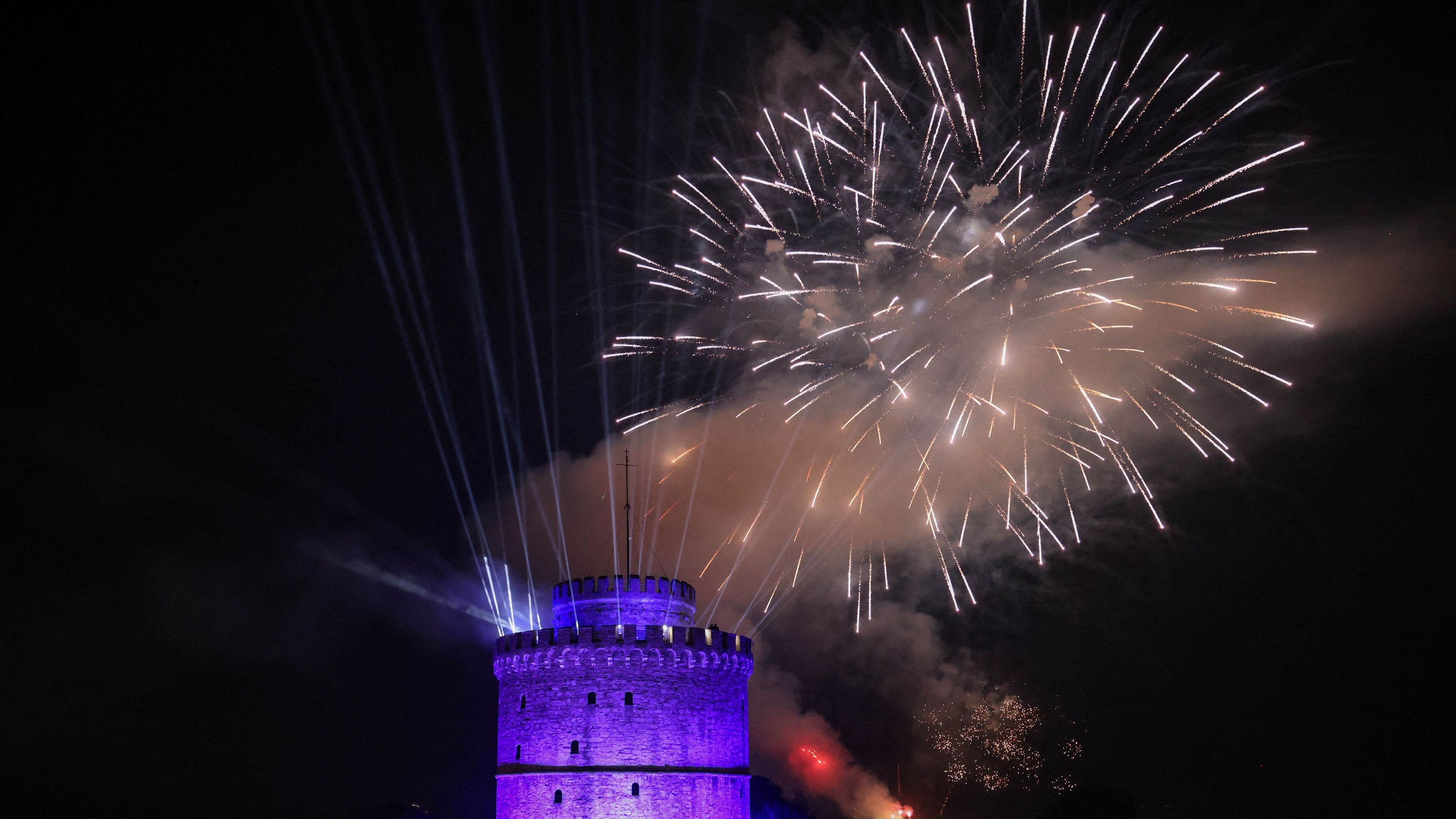 Fireworks explode behind the White Tower during New Year's celebrations in Thessaloniki, Greece.