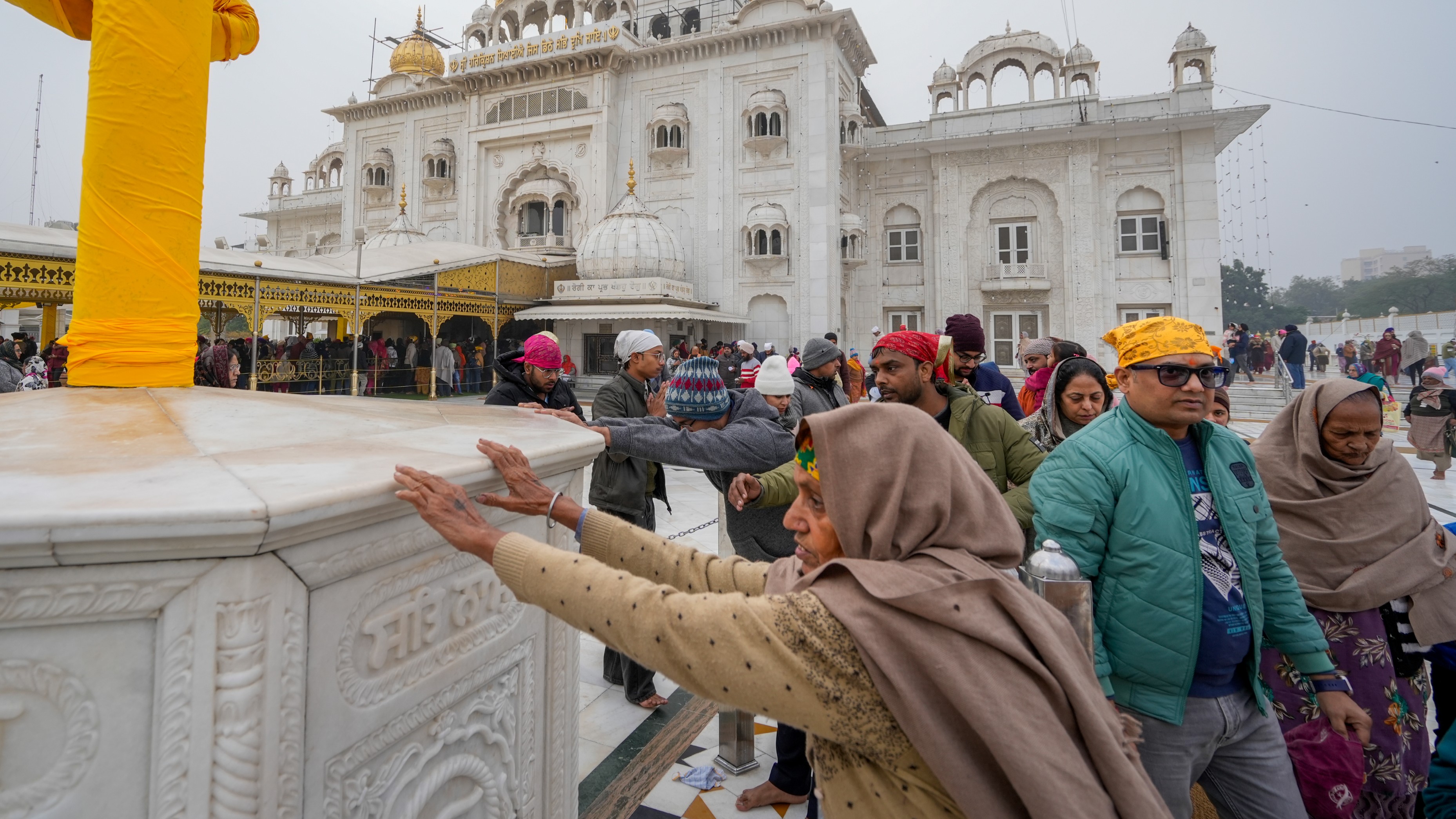 Devotees arrive to pay obeisance at the Gurdwara Bangla Sahib on the first day of the year 2025, in Delhi.
