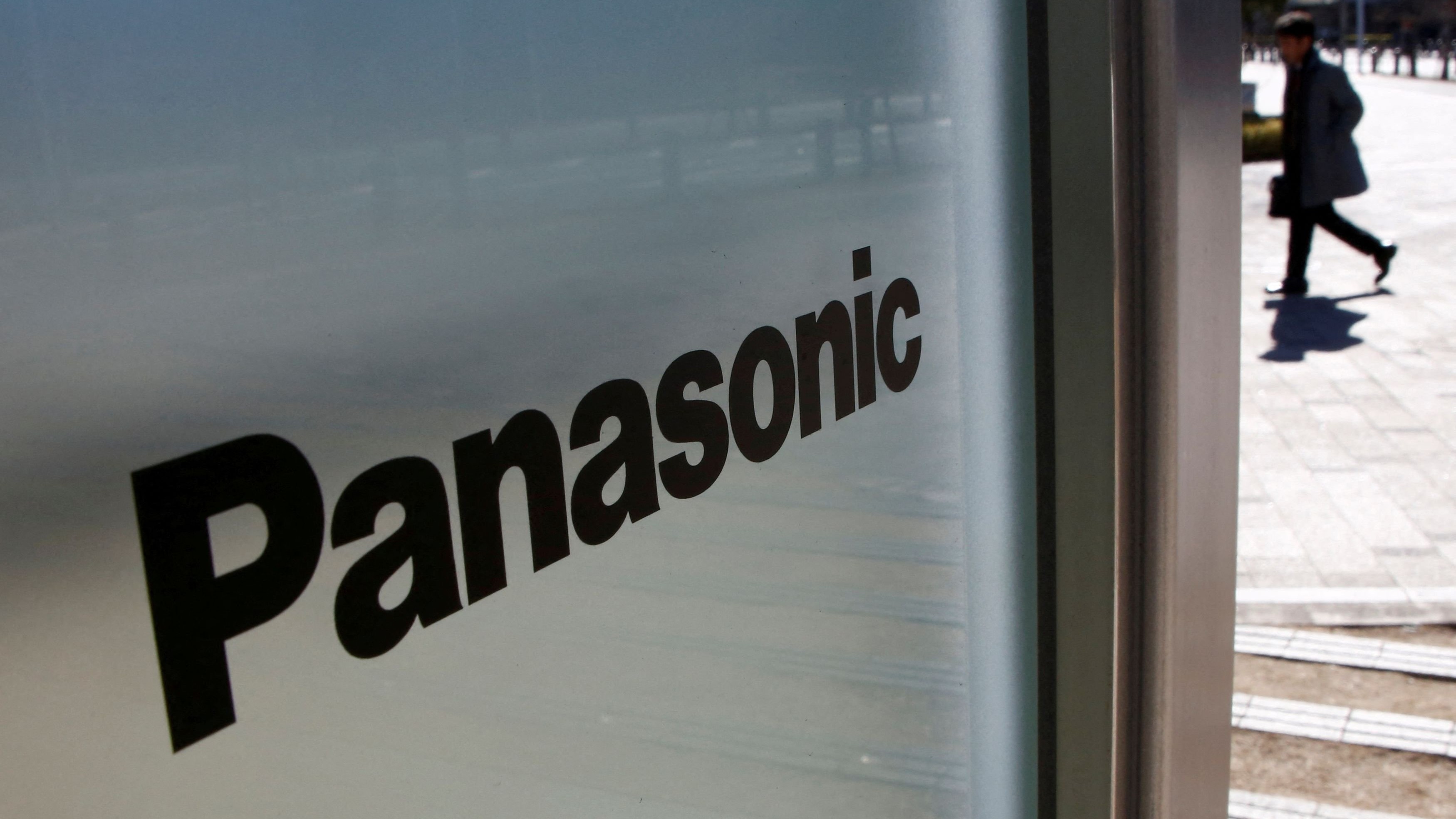 FILE PHOTO: A man is seen next to Panasonic Corp's logo at Panasonic Center.